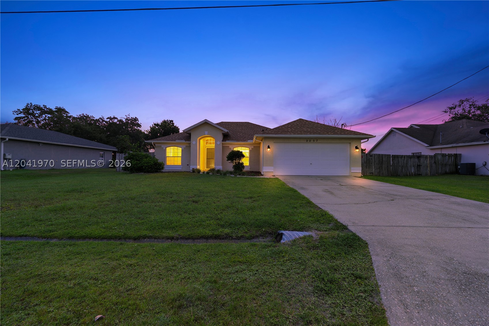 Welcome home to this beautifully maintained residence featuring a desirable split floor plan designed for both comfort and privacy. Enjoy outdoor living in the spacious, private fenced backyard with a stunning lanai perfect for entertaining, relaxing, or creating your dream outdoor oasis. The oversized yard offers ample room to add a pool. Additional upgrades include a NEW ROOF and a NEWER A/C system installed in 2024 for added peace of mind. Complete with a spacious 2-car garage, this home is a must-see.
