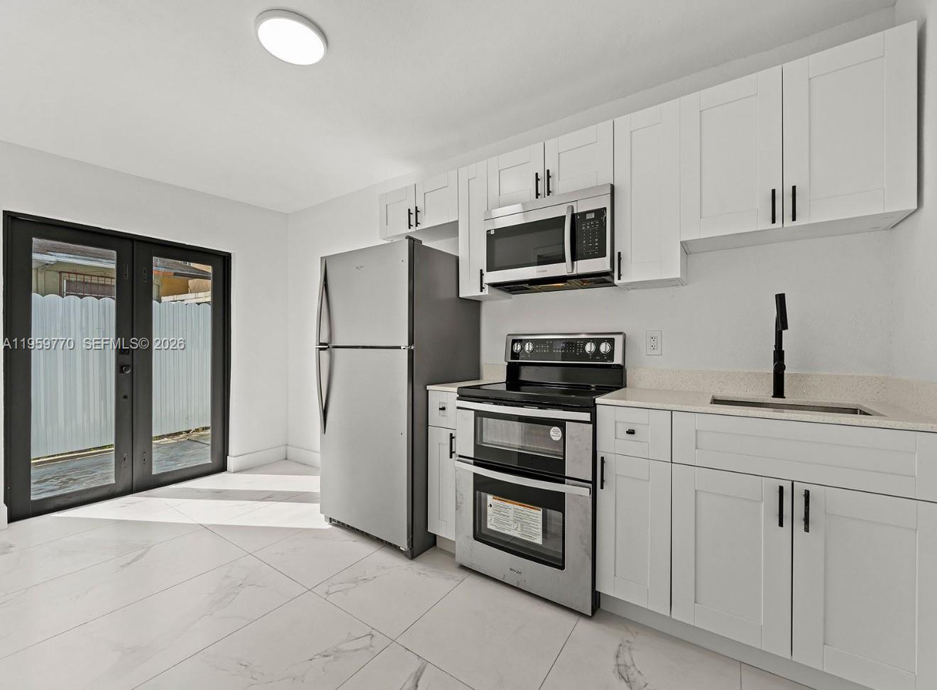 SPECIAL 1 YEAR LEASE!!! FIRST 6 MONTH RENT WILL BE $2000 THE NEXT 6 MONTHS  WILL GO UP TO $2350. Fully remodeled 2-bedroom, 1-bath rental in the heart of Miami! This bright and modern home features an updated kitchen and bath, in-unit washer and dryer, and a functional layout perfect for comfortable living. Enjoy the convenience of two dedicated parking spots and a private backyard, ideal for relaxing or entertaining. Centrally located near major highways, shopping, dining, and public transportation. Water and Electricity are covered are covered in the rental price!!!! Move-in ready and easy to show!