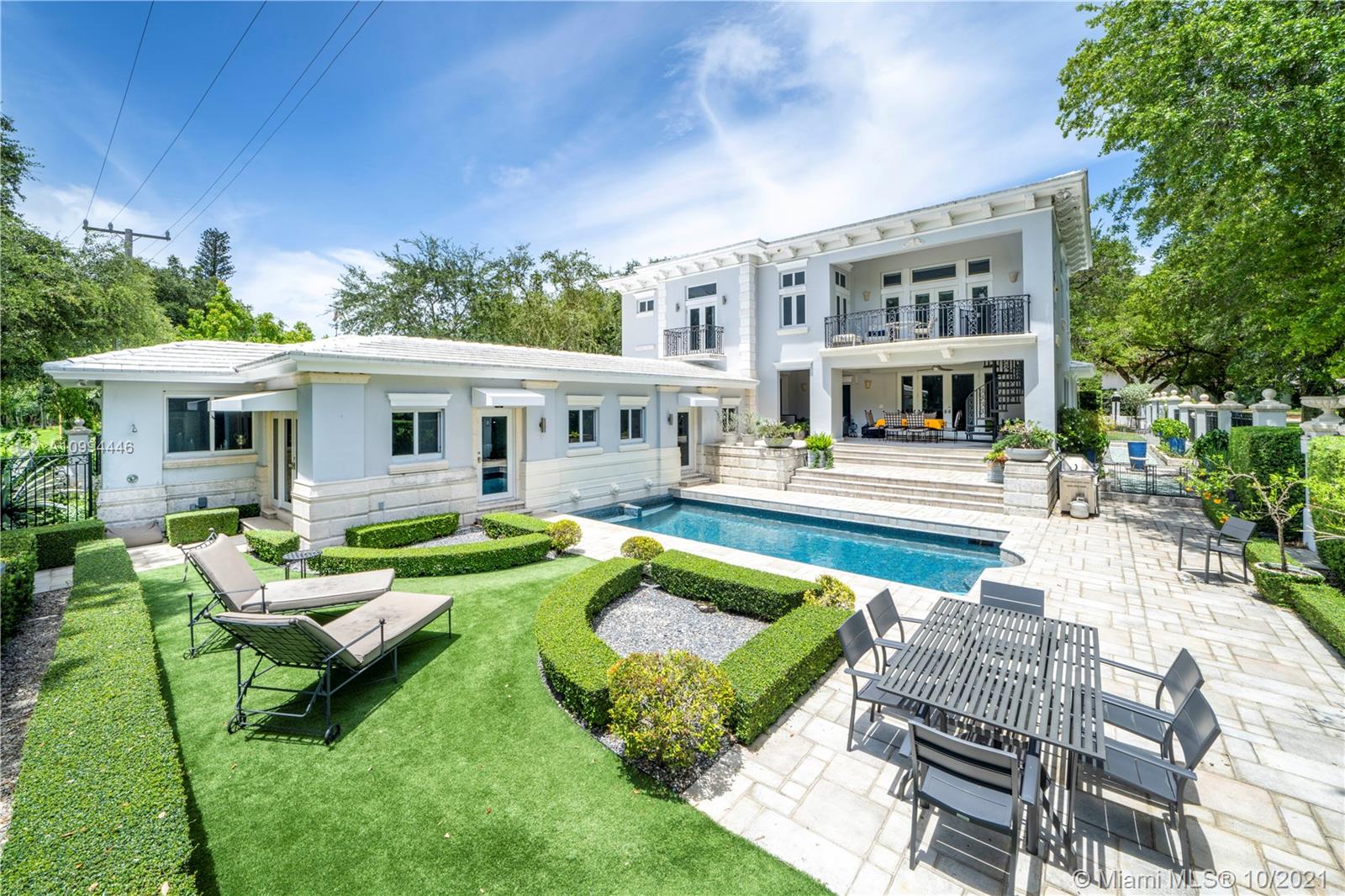 Proudly situated directly on the Gables waterway & prestigious Biltmore Golf Course stands this immaculate gated 7,040SF French inspired estate on an oversized 17,800SF lot. Feel zen within spectacular sculptured gardens by world renowned designer Fernando Wong. Enjoy multiple fabulous interior/exterior living spaces, pool deck, wine cellar, aviary & top-of-the-line sleek Snaidero gourmet kitchen. Cherish this residence's unique character, intricate moldings & craftsmanship throughout. Massive master suite w/ serene spa-like bath, expansive closets, office & private balcony w/ direct access to pool. Grand window-lined gallery like corridor leads to attached guest suite w/ 2nd kitchen & living space. Additional amenities: golf cart access onto the fairway + kayak launch from backyard.