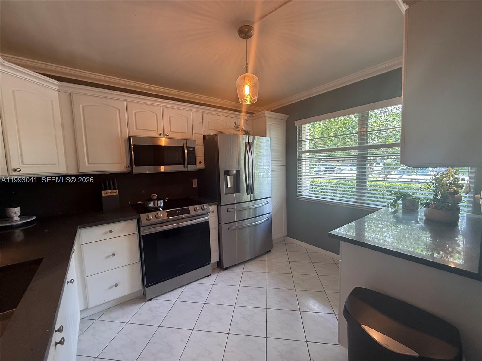Updated 2 bedroom 2 bath condo located in one on the most desirable villages in WYNMOOR ANTIGUA VILLAGE. THIS SPACIOUS 1,156 SQFT ON THE FLR  Offers great layout with tranquil garden view and the enclosed creen patio adds to the with a door to exit to the back enjoying the landscapes. The updated kitchen and amenities the community offers are all plus for those to enjoy like an amazing club house , Theater, lap pool, heated pool, walk paths , fitness gym and classes, this active community offers it all.