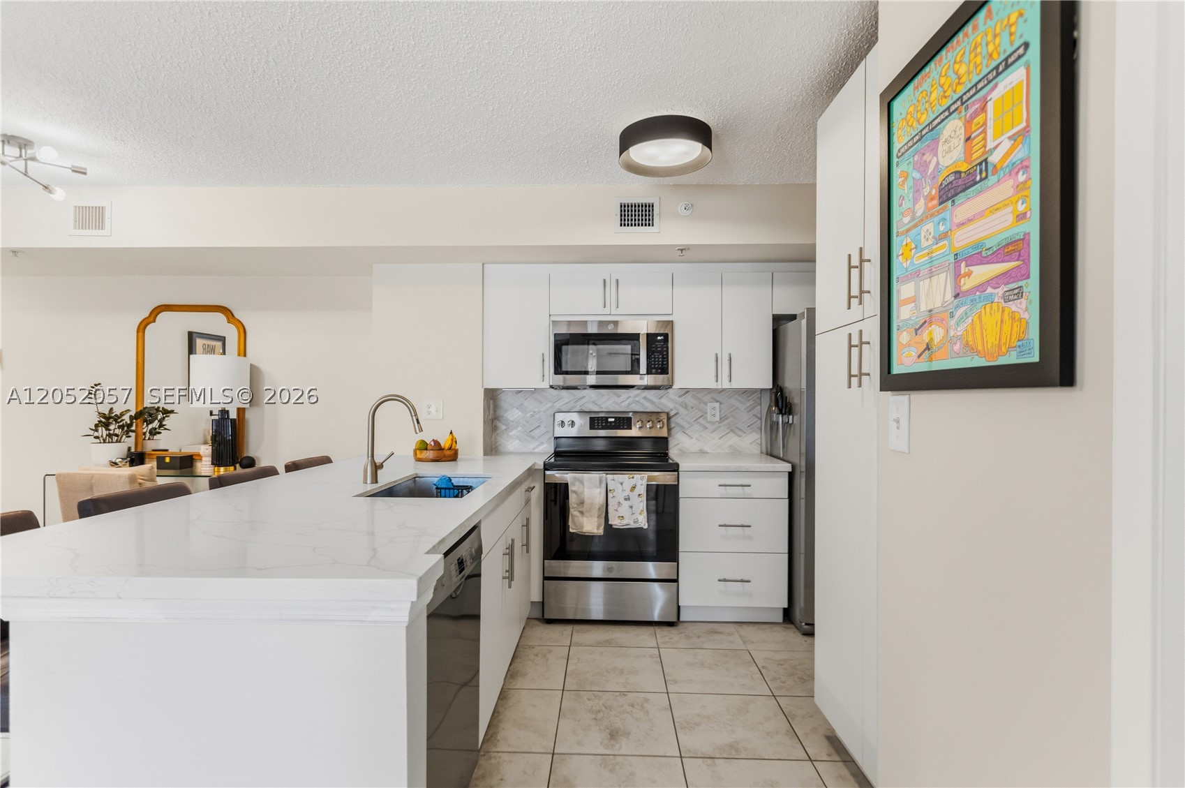 **Ready to move in!** Spacious first-floor corner condo featuring **two  assigned convenient parking spaces** in a highly desirable Davie location. This split-bedroom floor plan offers added privacy with only one neighboring unit, a bright open living area, and an oversized dining counter. The open kitchen features newer stainless steel appliances (2022). Enjoy community amenities including a pool, fitness center, tennis courts, and dog park. Conveniently located near Nova Southeastern University, Broward College, Florida Atlantic University, shopping, dining, major highways, beaches, and top-rated A+ schools. Ideal for professors, students, medical professionals, or anyone seeking a convenient place to call home.