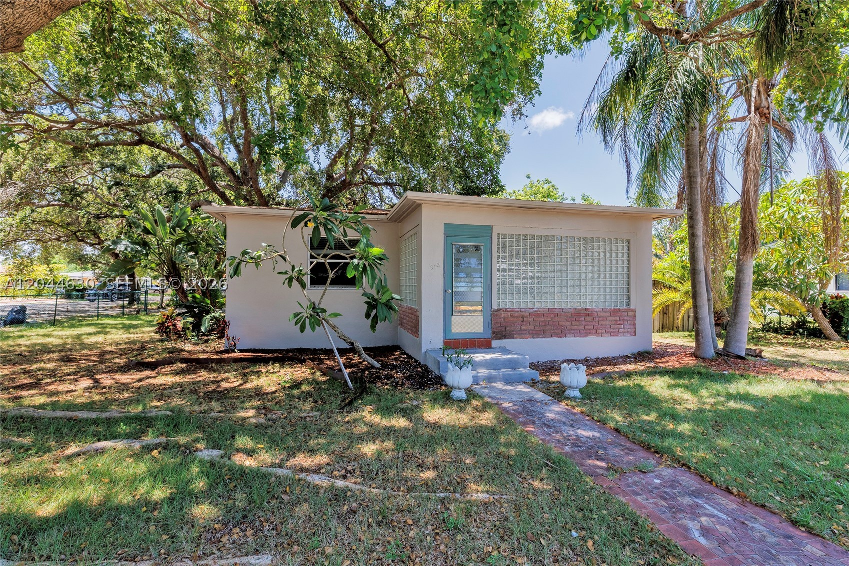 This charming two-bedroom, one bath home has been freshly painted inside and out and features a roof replaced under permit in 2017 and the air conditioner in 2022. The home is move-in ready but presents an excellent opportunity for a new owner to update the kitchen and/or bath to suit their style while building equity.
Situated on an oversized 8,208 sq. ft. fenced corner lot in desirable Hollywood Little Ranches, this property offers exceptional potential in one of Hollywood's most convenient locations. With mature landscaping and ample outdoor space, the lot provides endless possibilities for expansion, a pool, outdoor living, or creating your own private retreat.
Ideally located just minutes from downtown Hollywood, approximately 15 minutes from Hollywood Beach, and about 20 minutes from Aventura Mall, with convenient access to Fort Lauderdale-Hollywood International Airport and Miami International Airport, this property combines location, lot size, and opportunity. Whether you're looking for a primary residence, investment property, or renovation project, this is a chance to make the most of a generously sized corner lot in a well-established neighborhood. No HOA
