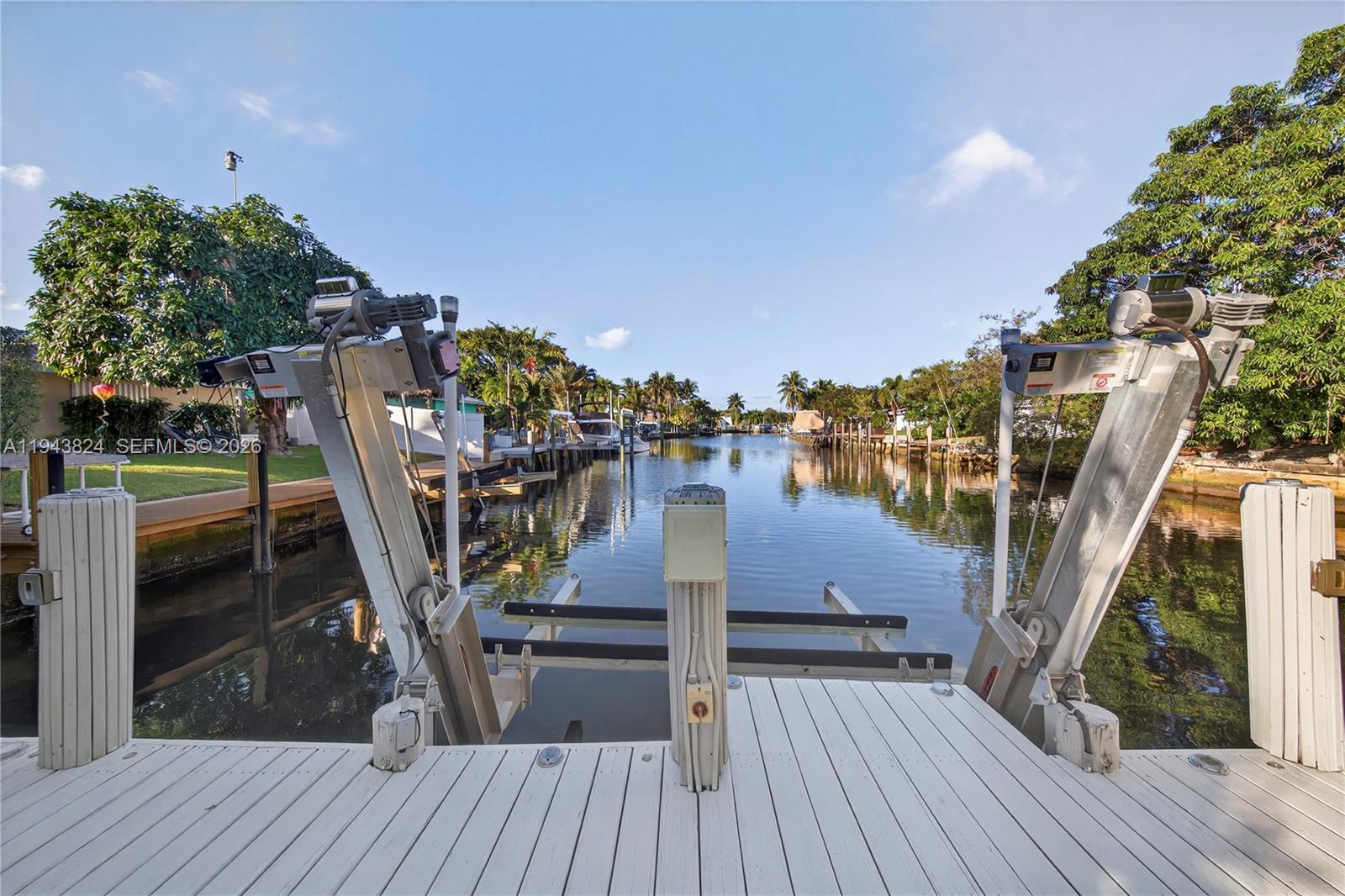 Welcome to Garden Isles, conveniently located near the beach, Pompano Pier, shopping, and restaurants. This 2-bedroom, 2-bath home with a spacious enclosed patio is situated in a desirable neighborhood primarily consisting of waterfront properties, often compared to the charm of Venice, Italy. Half the garage is now a laundry room with AC bringing it to 1,710 sq ft under air. The backyard offers a private, serene setting with expansive water views both day and night. The kitchen (2024) and bathrooms (2020) have been recently remodeled. Major updates include a newer roof (2019) and impact windows (2024). A/C and water heater (2020). Seawall approximately 49 ft in length, dock approximately 28 ft in length. A new 10,000 lb boat lift installed in 2021, making this home ideal for boating enthusiasts. The one-car garage has been converted to a storage area but can easily be reverted to a garage if desired. The home is available fully furnished; TVs are excluded from the sale price. Property rented at $4,600 per month until May 14th 2027.