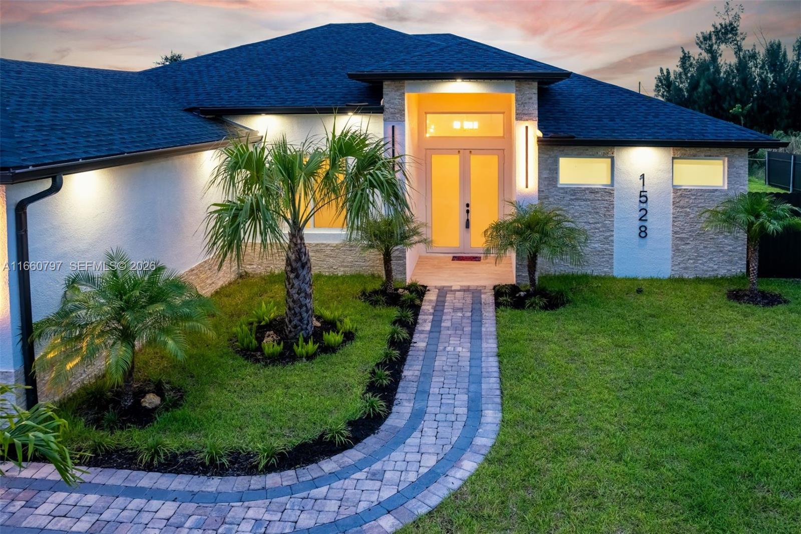 Introducing a stunning waterfront estate that epitomizes luxury living. This newly home features 4 spacious bedrooms and 3 elegant bathrooms, complemented by a three-car garage. Step outside to discover a breathtaking pool with a waterfall, a cozy firepit, and a built-in BBQ, perfect for outdoor gatherings.
Inside, the residence boasts a gourmet kitchen with sleek European-style cabinets, a stone wine rack, and pristine quartz countertops. The open-concept layout and soaring ceilings create a bright and inviting atmosphere, enhanced by sophisticated tile flooring. Hurricane-impact windows provide both security and peace of mind.
Enjoy the outdoor space with ceiling fans on the patio ensuring optimal airflow.