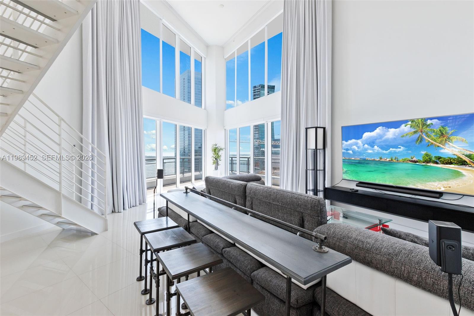 This stunning two-level corner unit boasts three bedrooms, three baths, plus a powder room, offering breathtaking panoramic views of the Miami skyline, city, bay, and ocean from every room. With double-height ceilings, an open kitchen, custom-built walk-in closets, window treatments, and tile floors throughout, this residence exudes luxury.

The building features a contemporary lobby, gym, jacuzzi, pool, and spa with cold plunge, providing residents with top-notch amenities. With 24-hour front desk and valet parking, it offers full-service convenience.

Situated within walking distance to Brickell's vibrant scene, including shopping, restaurants, Mary Brickell Village, Brickell City Centre, and more, this property epitomizes sophisticated urban living.