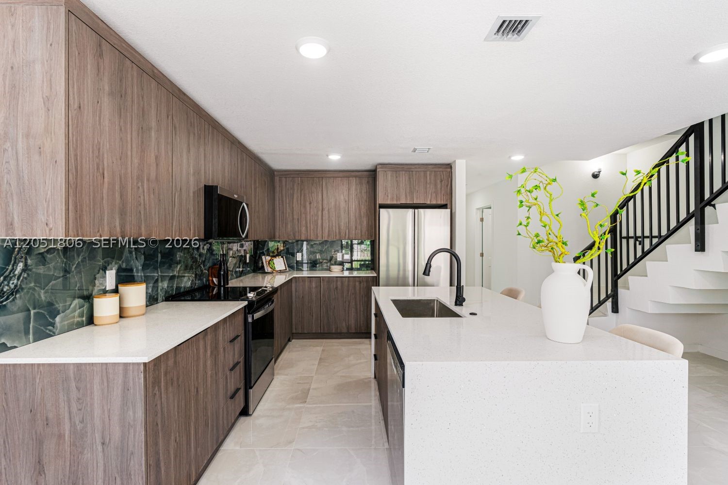 ***LOCK IN A LOW RATE + CLOSING COST CREDITS TODAY*** this home sits directly across from On Centro's community park and Visitor Parking, giving your family instant access to green space right outside your door. Step inside this Collection N floorplan offering 4 bedrooms (including a first-floor bedroom), 3 full bathrooms, and an island kitchen. Built with Pure Concrete X+ Construction, this home delivers real savings and true storm-ready peace of mind. Inside you'll find quartz countertops, stainless-steel appliances, porcelain tile flooring, and hurricane impact windows and doors throughout. Low HOA. Minutes from US-1, Florida's Turnpike, and Krome Avenue, with quick access to the Florida Keys and Homestead's top schools, shopping, and dining. Request A Showing Today. Ask about Rate Specials rate and closing cost incentives!