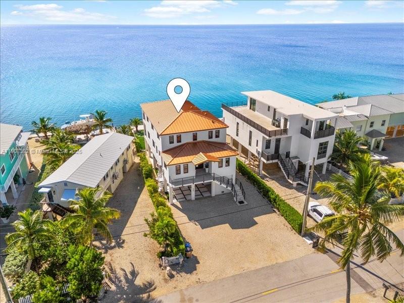 Wake up to endless ocean views at this stunning 5-bedroom, 4-bath waterfront home in the heart of Tavernier. Designed for relaxation & entertaining, the property features an infinity-edge pool, private dock with direct ocean access, & breathtaking vistas from every level. Just minutes by boat to one of the Keys’ most beautiful sandbars, this home offers the ultimate Florida Keys lifestyle. Inside, enjoy an open-concept living area with a gourmet kitchen, contemporary coastal design, and expansive balconies overlooking the Atlantic.  Located near waterfront dining, shopping, and entertainment, this move-in-ready home is a rare opportunity to own a slice of paradise in the Upper Keys.
