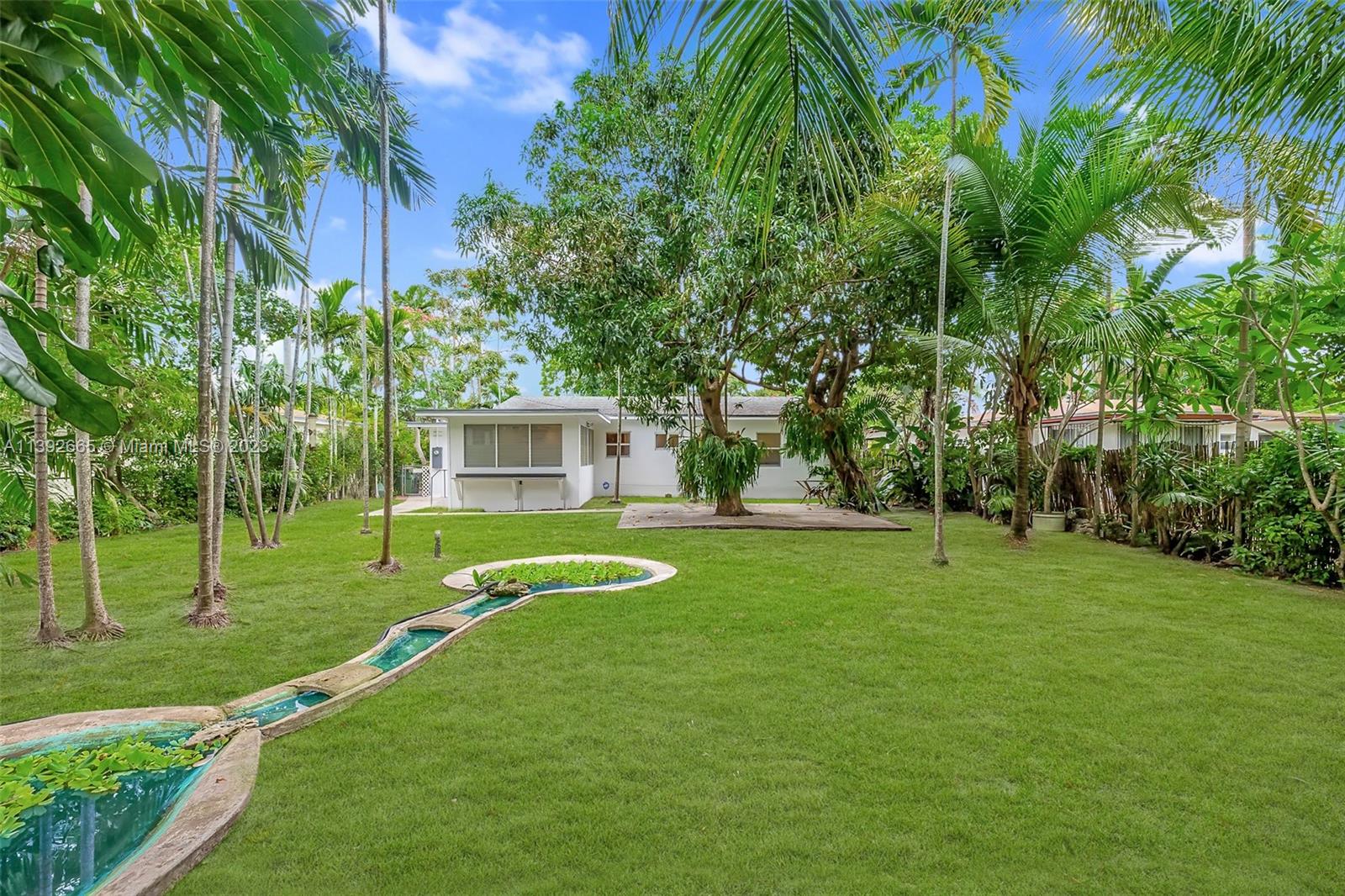 Dream Oasis Nestled in Adorable Walkable N. Miami! Charming Mid-Century Home, SPECTACULAR, LUSH YARD w/ Amazing Mature Trees—a Serene, Private Retreat. Soothing Sounds of Cascading Waterfall + Pond in the Backyard. Large Master Suite w/ Flowing, Split Floorplan. Phenomenal Florida Room, Excellent Terrazzo Floors, All IMPACT WINDOWS & DOORS (except FL Room) + Separate Utility Room. Beautifully Maintained + Move-In Ready: UPDATED PLUMBING AND ELECTRIC, Central AC, Roof in great shape ('05), Awesome 8X10 Shed for Additional Strg. Wonderful Community... Walk to French Cuisine, Italian, Coffee Shops, City Hall, Police Dept. MOCA Museum of Contemporary Art, Monthly Food+Wine Tasting, Music, Holidays! 4 Mins to Wholefoods, 10 to Beach, 14 to Wynwood, 15 to Brickell, 16 to Airport. CALL!