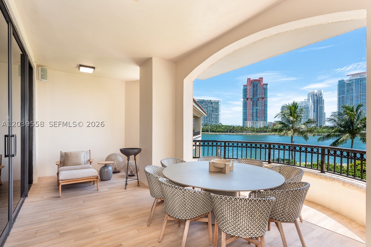 Located on exclusive Fisher Island, Residence 6822 at Palazzo Della Luna is an exceptional 3-bedroom, 3.5-bath, offering approximately 3,600 SF of refined interiors, complemented by expansive wraparound terraces with sweeping views of the ocean, Government Cut, marina, and Miami Beach skyline. A private elevator opens to an airy, open-concept layout framed by 10-foot floor-to-ceiling glass and wide-plank European oak flooring throughout. The Boffi-designed kitchen is impeccably appointed with Miele and Sub-Zero appliances, wine refrigeration, and elegant stone surfaces. The spacious primary suite is a tranquil retreat featuring direct water views, terrace access, walk-in closets, and a spa-inspired bath with Italian marble, a glass-enclosed rain shower, and a sculptural soaking tub. Every room opens to the oversized terrace, creating seamless indoor-outdoor living. Palazzo Della Luna offers world-class amenities including 24-hour concierge and valet, private pools, fitness and wellness facilities, on-site dining, and access to Fisher Island’s exclusive lifestyle including the private beach club, golf, tennis, spa, and fine dining.