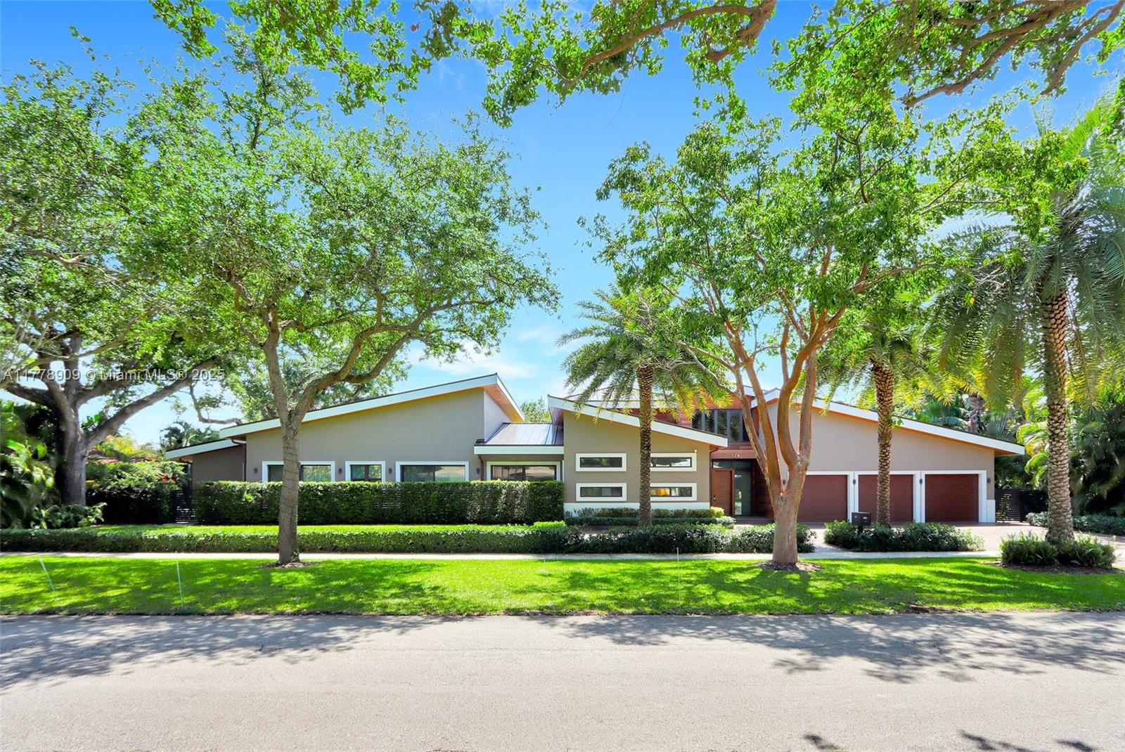 Experience luxury living in this stunning 5,646 sq ft under AC modern home blended modern design and exceptional craftsmanship, nestled on a lush 19,000 sq ft lot and built in 2019. This elegant residence offers 4 spacious bedrooms, including 2 primary suites, 3 full baths, 2 half baths, a chef’s kitchen,informal and formal dining rooms and a flex space perfect as a gym or playroom. A beautiful office easily doubles as a library or cozy den. Step outside to your private oasis featuring a heated pool, outdoor kitchen, and expansive patio. A 3-car garage and prime location near I-95 and vibrant NE 2nd Ave complete the package. Sophistication, space, and style await.