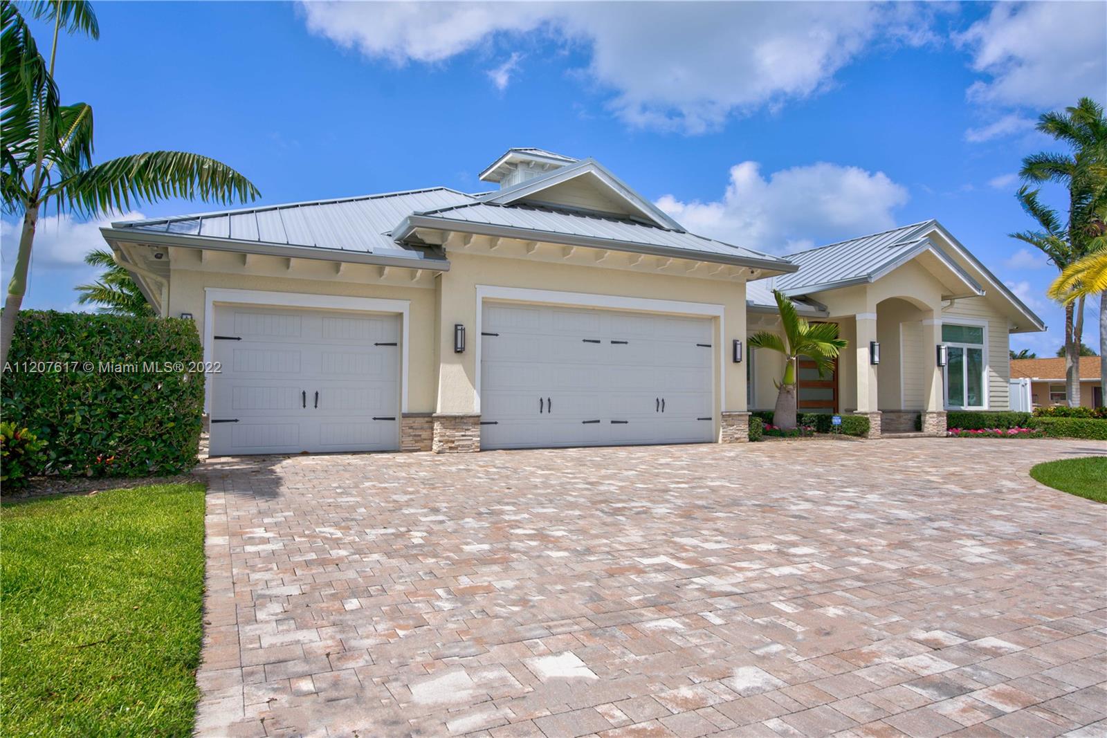 Incredible value at this stunning, modern estate home on 100' of waterfront has it all! Designer finishes and fully furnished. Salt water pool with spa and jets.  One of the best ''NO HOA'' streets in PBG, wide/deep salt water canal. No fixed bridges & easy ocean access. This newer premier estate home has 5 bedroom, 5.1 bath plus office, 3 car garage, impact glass 24KW generator, 24K boat lift. Tiki bar, outdoor kitchen, oversized covered living/dining with motorized screens.  Gourmet gas appliances. Open concept with no detail left undone.  Walk through this Mahogany door into a spectacular foyer with wood tray ceiling and salt water fish tank.  Master bedroom plus 3 additional en suite bedrooms plus office in the main house and separate 1/1 guest house/casita
