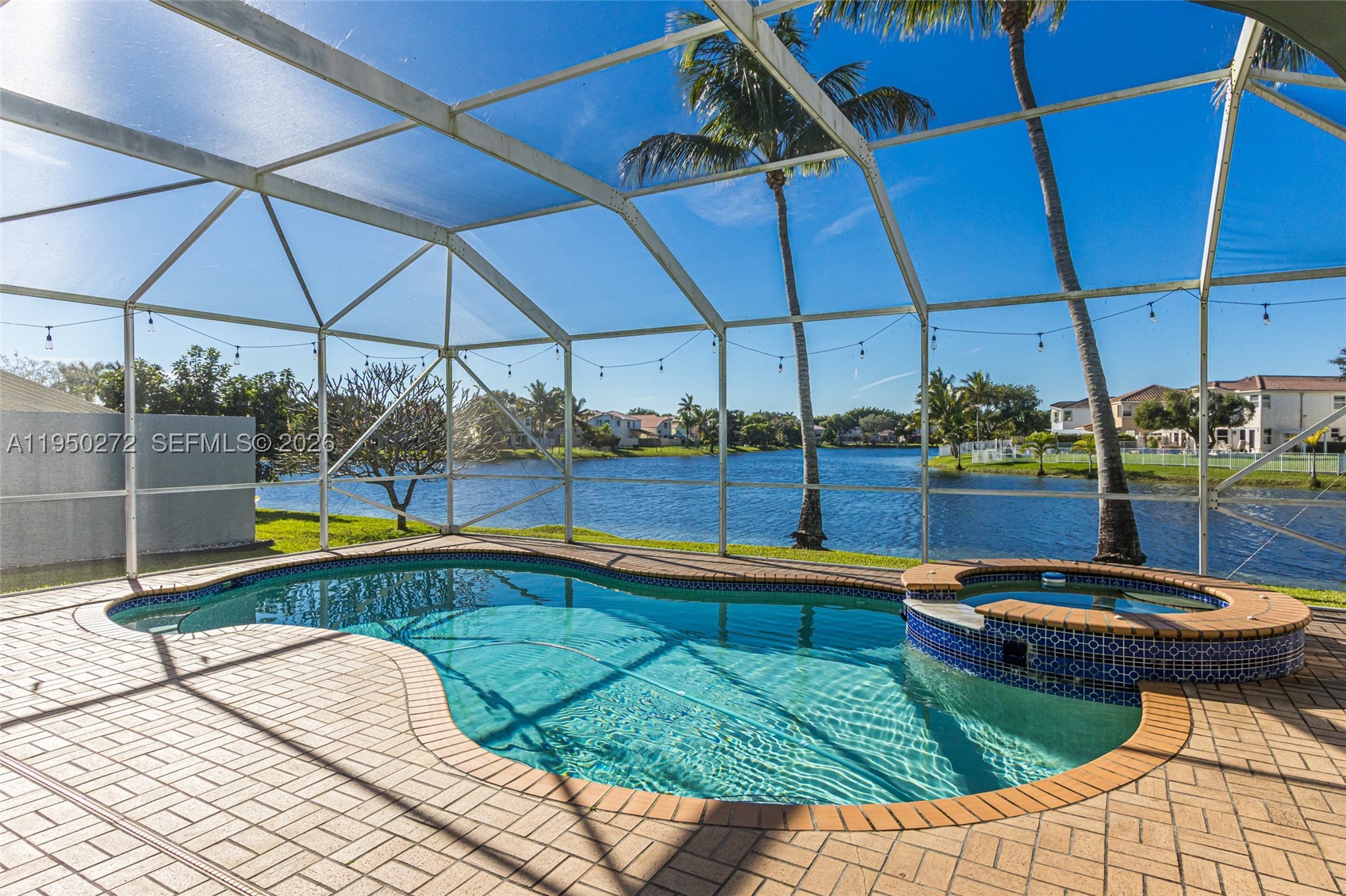 Serene Lakefront Living in Gated Community. Experience the perfect blend of tranquility and security in this  stunning two-story residence. Boasting 4 bedrooms and 2.5 baths, this home captures breathtaking water views from a private, screened-in pool deck. The primary suite serves as a true retreat, complete with a dedicated sitting area. Well  maintained and ready for your personal touches. Low HOA maintenance fees. Brand-new 2025 roof, accordion shutters, and a water purification system. Amenities including a clubhouse, gym, and multiple pools—this is a rare opportunity to own a piece of the sought-after Towngate lifestyle.