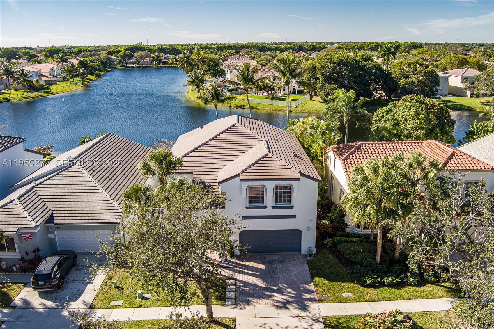 Serene Lakefront Living in Gated Community. Experience the perfect blend of tranquility and security in this  stunning two-story residence. Boasting 4 bedrooms and 2.5 baths, this home captures breathtaking water views from a private, screened-in pool deck. The primary suite serves as a true retreat, complete with a dedicated sitting area. Well  maintained and ready for your personal touches. Low HOA maintenance fees. Brand-new 2025 roof, accordion shutters, and a water purification system. Amenities including a clubhouse, gym, and multiple pools—this is a rare opportunity to own a piece of the sought-after Towngate lifestyle.