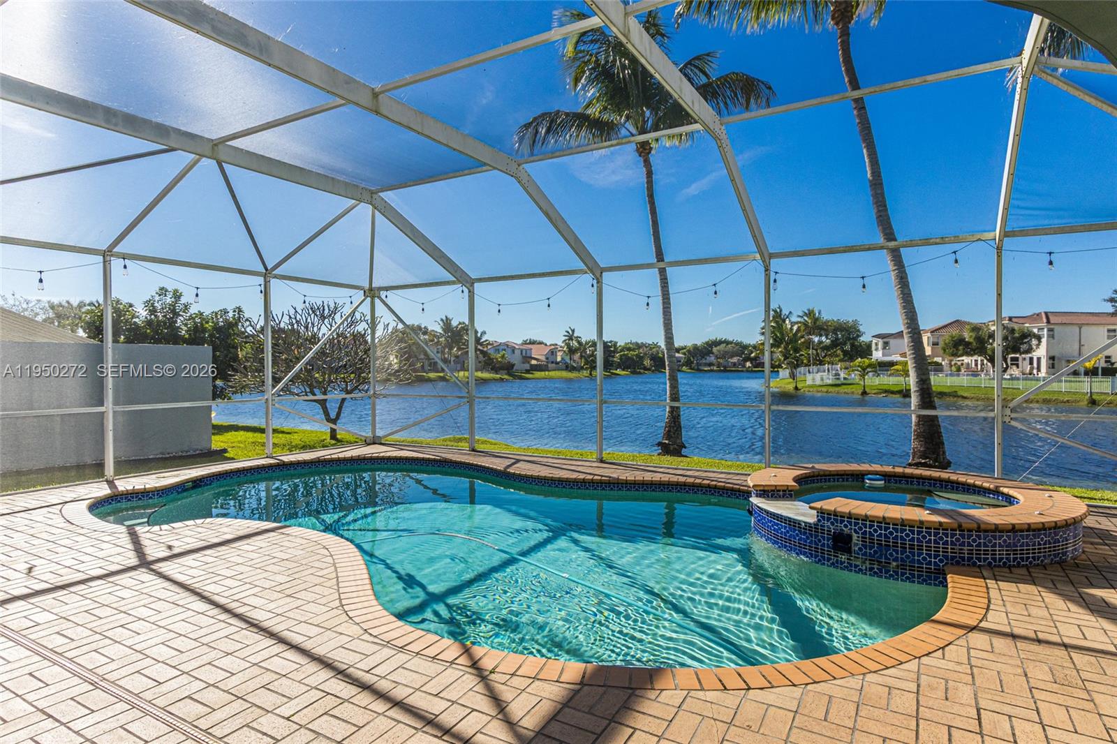 Serene Lakefront Living in Gated Community. Experience the perfect blend of tranquility and security in this  stunning two-story residence. Boasting 4 bedrooms and 2.5 baths, this home captures breathtaking water views from a private, screened-in pool deck. The primary suite serves as a true retreat, complete with a dedicated sitting area. Well  maintained and ready for your personal touches. Low HOA maintenance fees. Brand-new 2025 roof, accordion shutters, and a water purification system. Amenities including a clubhouse, gym, and multiple pools—this is a rare opportunity to own a piece of the sought-after Towngate lifestyle.