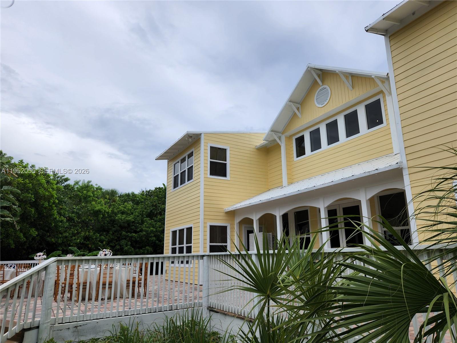 BED AND BREAKFAST AND WEDDING VENUE!  Welcome to this beautifully remodeled beach home featuring 6 spacious bedrooms, each with its own private ensuite bathroom,+ a convenient half bathroom downstairs. The home also has 2 other versatile rooms, perfect for an office, extra bedrooms or a home gym.  Enjoy peace of mind with brand-new impact windows and doors, delight in the elegant dining room and chef’s kitchen ideal for family gatherings. Natural light fills every room, creating a bright and welcoming atmosphere. On a cold winter you can snuggle with your family in front of the fireplace in the spectacular great room featuring 20ft ceilings and an elegant chandelier. Nestled on an expansive waterfront corner lot of over 28,000 square feet, this property boasts a private boat dock, perfect for water adventures & fishing, and is located in the serene town of North Hutchinson Island.  Enjoy the breathtaking sunset on the Lagoon while lounging on your back porch, have cocktails as you listen to the waves from your 2nd floor oceanfront deck, and a romantic walk on the beautiful white sandy beach just steps away. The home boasts a large patio great for entertaining and parties. The beach house is also licensed as a Bed & Breakfast and A Special Events Venue for Weddings & Private Parties. The home also has a 2 car garage as well as a parking area that can accommodate up to 17 cars. Play a game of volleyball, pickleball or tennis at the courts across the street at Pepper Park.