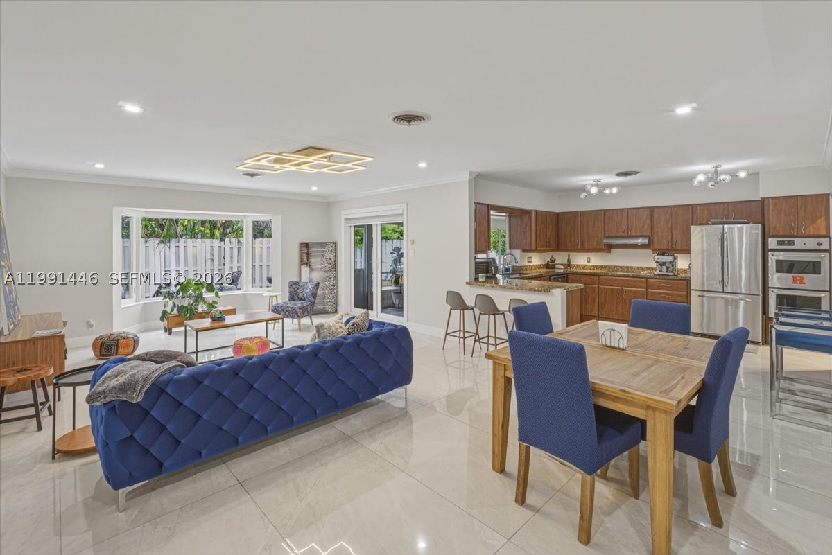 BEST-PRICED HOME IN JENADA ISLE, WILTON MANOR! Exceptional opportunity to own in this prestigious gated community. Offering 2,000+ sq ft under air on an oversized 8,495+ sq ft lot, this move-in ready home features a desirable split floor plan, spacious primary suite, and generously sized guest bedrooms. Impact windows & doors, open-concept kitchen, crown molding throughout, and abundant natural light. Private backyard with mature fruit trees, perfect for relaxing or entertaining. Additional highlights include tile roof (2001), A/C only 10 months old, oversized laundry room, circular driveway, and gutters for added protection. Prime location near Wilton Manors, Fort Lauderdale, beaches, dining, shopping, and I-95. Ready for you to move in and make it your home. Recently appraised at $800,000, submit your highest and best offer.