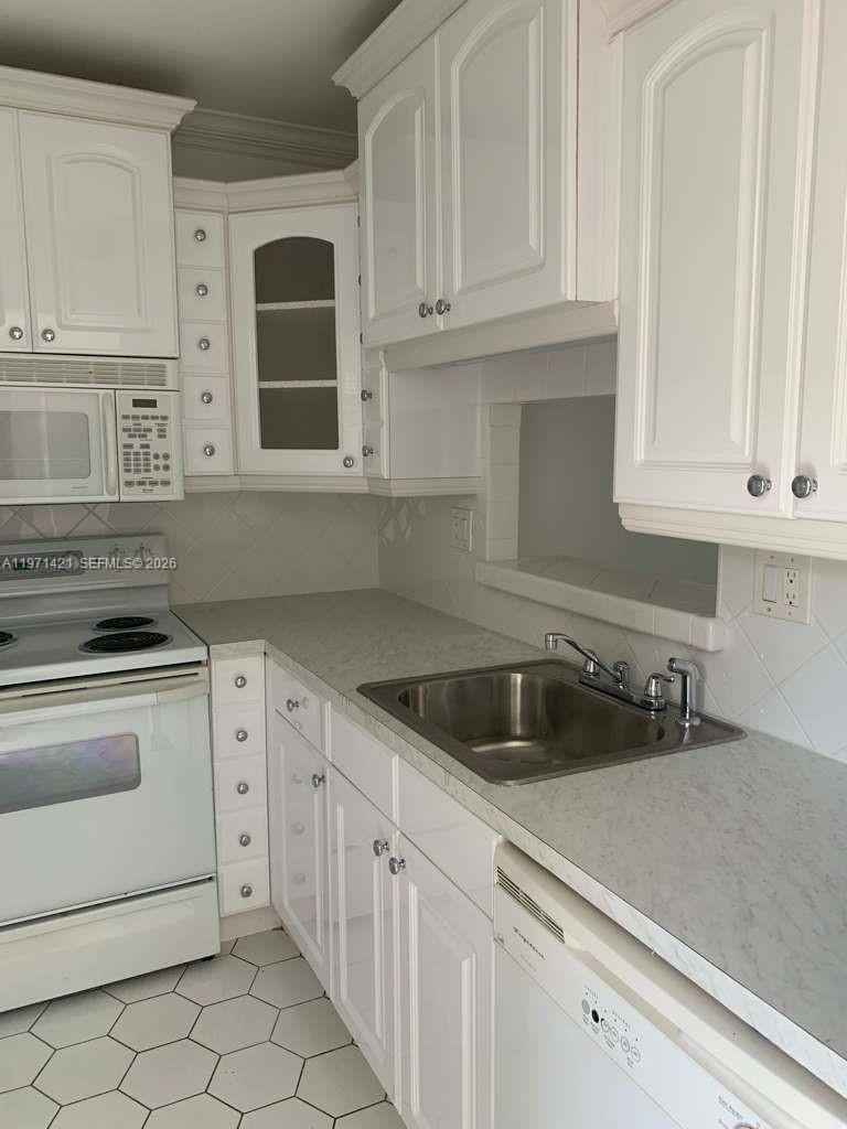 Beautiful 1-bedroom, 1-bath first-floor condo featuring a lovely lake view and convenient parking right in front of the unit. This 55+ community offers a spacious walk-in closet and an enclosed patio that can be used as a den or home office. Enjoy a wide range of amenities including a swimming pool, fitness center, shuffleboard, billiards room, and a large clubhouse with a full kitchen. Ideally located near shopping, medical centers, the Turnpike, and Oakland Park Blvd. Quiet and well-maintained community.
