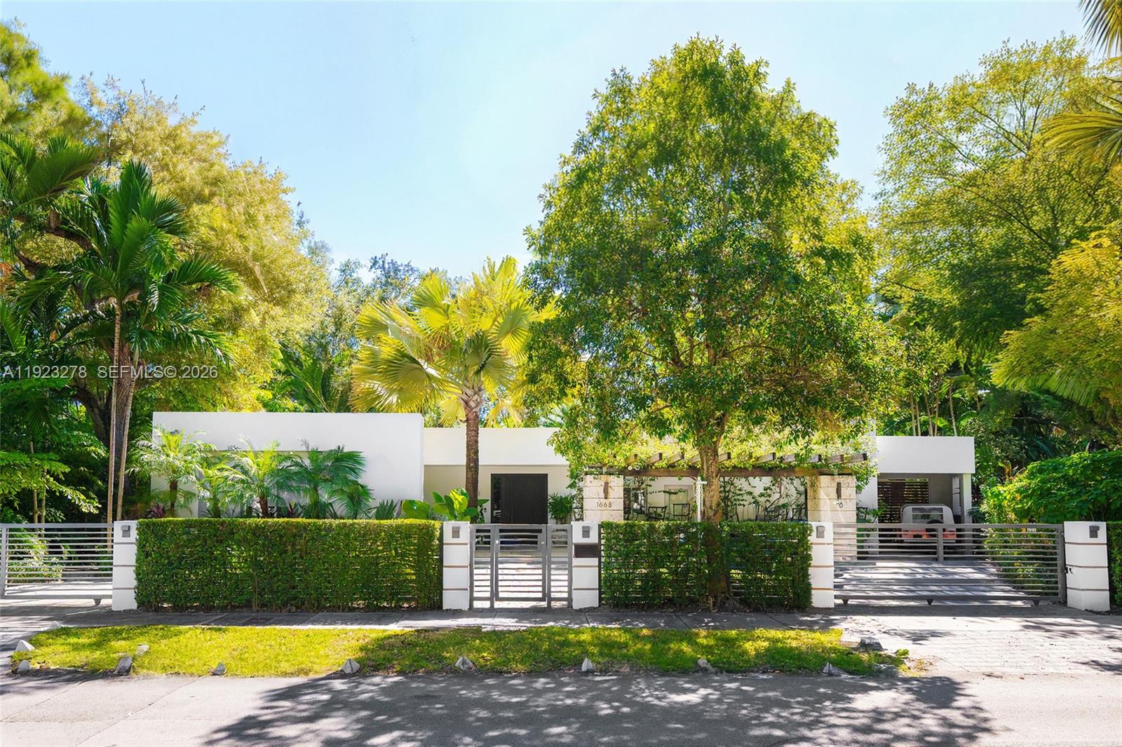Contemporary modern home w/ stunning designer renovation in North Coconut Grove! This 5BD/5+2BA 3,379 SF residence sits on a lush 13,375 SF lot in a tree-lined neighborhood. The entryway flows seamlessly to the chic living & dining areas w/ marble flooring & floor-to-ceiling windows overlooking the serene backyard w/ resort-style pool, covered summer kitchen & cabana bath w/ outdoor shower. Custom kitchen w/ large eat-in counter, top-tier Miele appliances & custom Ital Kraft built-ins. The spacious principal suite boasts double-height vaulted ceilings, white oak floors, custom walk-in closet & spa-inspired bath w/ 2 vanities, large marble rain shower & separate soaking tub. 4 guest bedrooms w/ en-suite baths - including staff room. Incredible location near top schools, fine dining & shops.