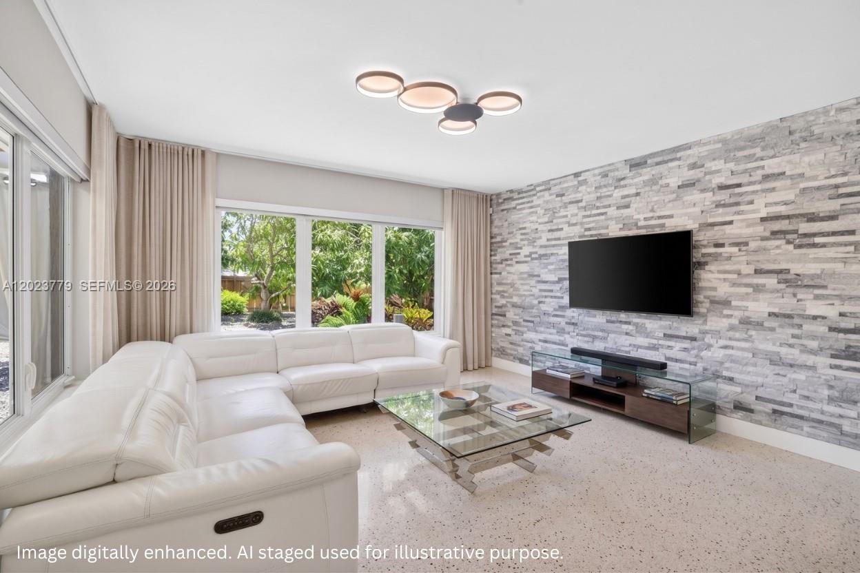Renovated split floor plan home in Hallandale Beach with terrazzo floors, FULL IMPACT WINDOWS & DOORS and a ELECTRIC STONE SURROUND FIREPLACE. Three independent AC systems including a dedicated thermostat for the primary suite keep energy bills averaging just $85 to $135/month. The open kitchen with granite countertops flows into an AIR CONDITIONED GARAGE converted into a flex space, home gym, or workspace, complete with a laundry area and quartz counters. Major upgrades include a 2017 ROOF, updated electrical panel, insulated plumbing, and a WiFi controlled well irrigation system. The FULLY FENCED yard w/ MATURE FRUIT TREES: mango, avocado, peach, and guava with room to add a pool. Parking stands out with a heavy duty concrete driveway, ELECTRIC BACK GATE for large trucks or trailers, and gated rear alley access for secure RV or BOAT STORAGE. For approximately $11/month, residents can opt into the nearby city park membership which includes a gym, tennis courts, and playgrounds. Whether you are searching for a move in ready Hallandale Beach home with low utility costs, flexible indoor outdoor living, RV parking, or a pool ready yard with fruit trees, this property checks every box.