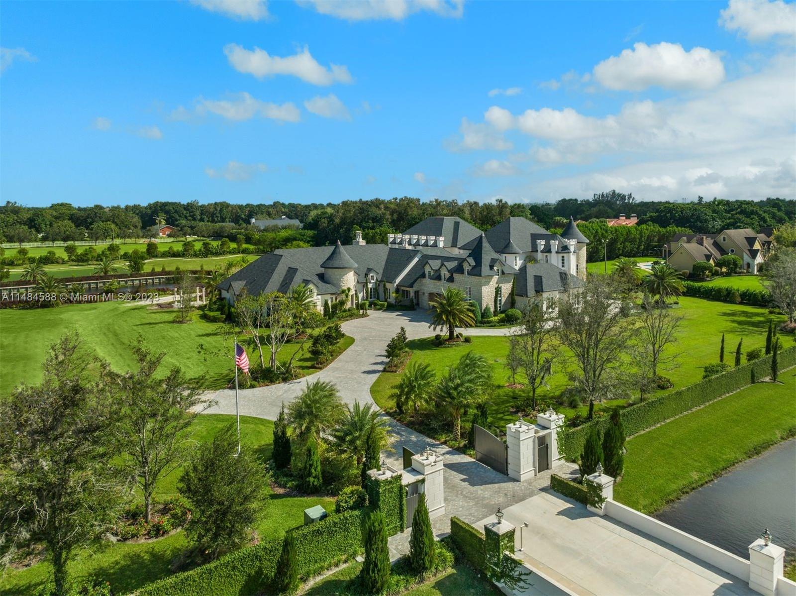 Bask in the grandeur of this nearly 8-acre Southwest Ranches estate, an architectural marvel transcending luxury living. This newly designed manor is the essence of resort-style living blending state-of-the-art features w/timeless elegance. Upon entering, you’re met with vaulted ceilings & a great room with a wood burning fireplace & French doors leading to a romantic rose garden. Outdoors, a summer kitchen with brick pizza oven sits adjacent to a large courtyard comprised of the pool & massage/meditation space. Discover a sprawling man cave reminiscent of a Jazz Age speakeasy complete with a full bar & wine room. An indoor basketball court w/viewing deck, gym, theater & game room complete the entertainment wing. With land to further expand, this family compound offers it all!