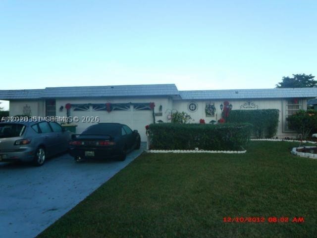 Come see an adorable 2 bedrooms and 2 bath home with a double garage and a large patio. Florida room can easily convert into 2 additional room and use the enclose patio as a family room. Tranquil lake at the back to enjoy the view; the view is spectacular and lake has retaining wall. Screened patio at the back to relax, barbecue or just extra storage. Driveway is wide for plus 4 cars. A/c is a few months old, new washer, dryer, refrigerator, dishwasher all are new. Owner has enjoyed this home and neighborhood is quiet and close to the FL Turnpike. Showings is easy just contact the agent. Reduce price for quick sale. Reduce price for quick sale. Easy to show. Motivated owner