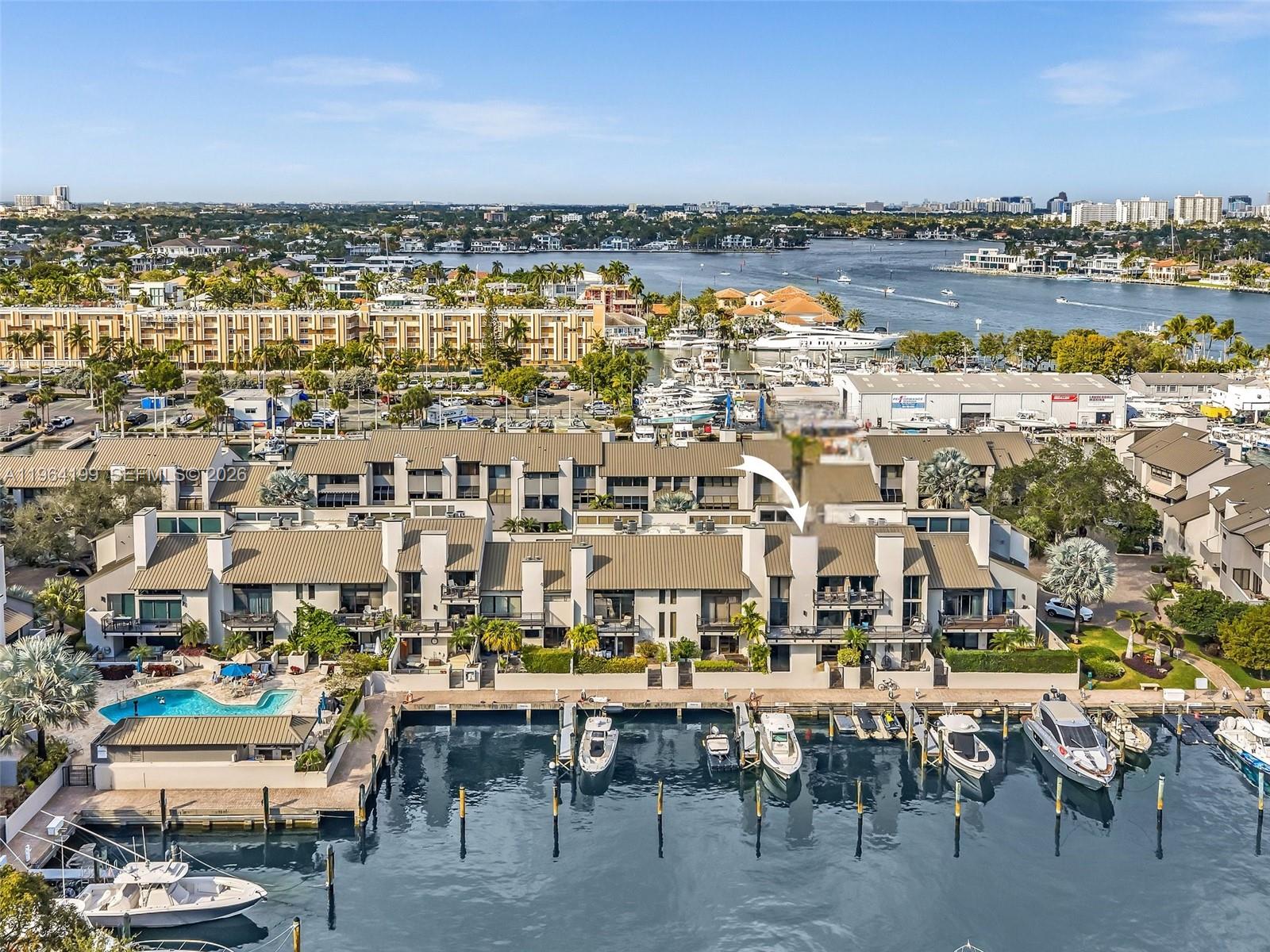 Less than five minutes from your dock to the ocean! This boater’s paradise is nestled inside a private, gated community in the heart of Port Everglades. With your own 55-foot deeded dock just steps from your back door, this home offers the ultimate boating lifestyle. Beautifully renovated, 2-bedroom + loft, 2.5-bath townhome has been completely updated with exceptional attention to detail. The main living area features soaring 22-ft ceilings, a stately fireplace, and serene water views. The chef’s kitchen offers custom cabinetry, quartzite countertops, glass backsplash, stainless steel appliances, and a wine cooler, overlooking a spacious dining area ideal for entertaining. The primary suite includes a built-out oversized closet and spa-inspired bath with dual vanities, rain shower, and soaking tub. All bathrooms have been fully renovated with refined finishes. The middle level hosts the main living and kitchen areas, the top level offers a private primary suite and loft, and the lower-level bedroom opens to a patio with direct dock access. Additional features include hurricane impact windows and doors. Enjoy marina views from three balcony levels, combining elegant, private waterfront living with effortless boating access.