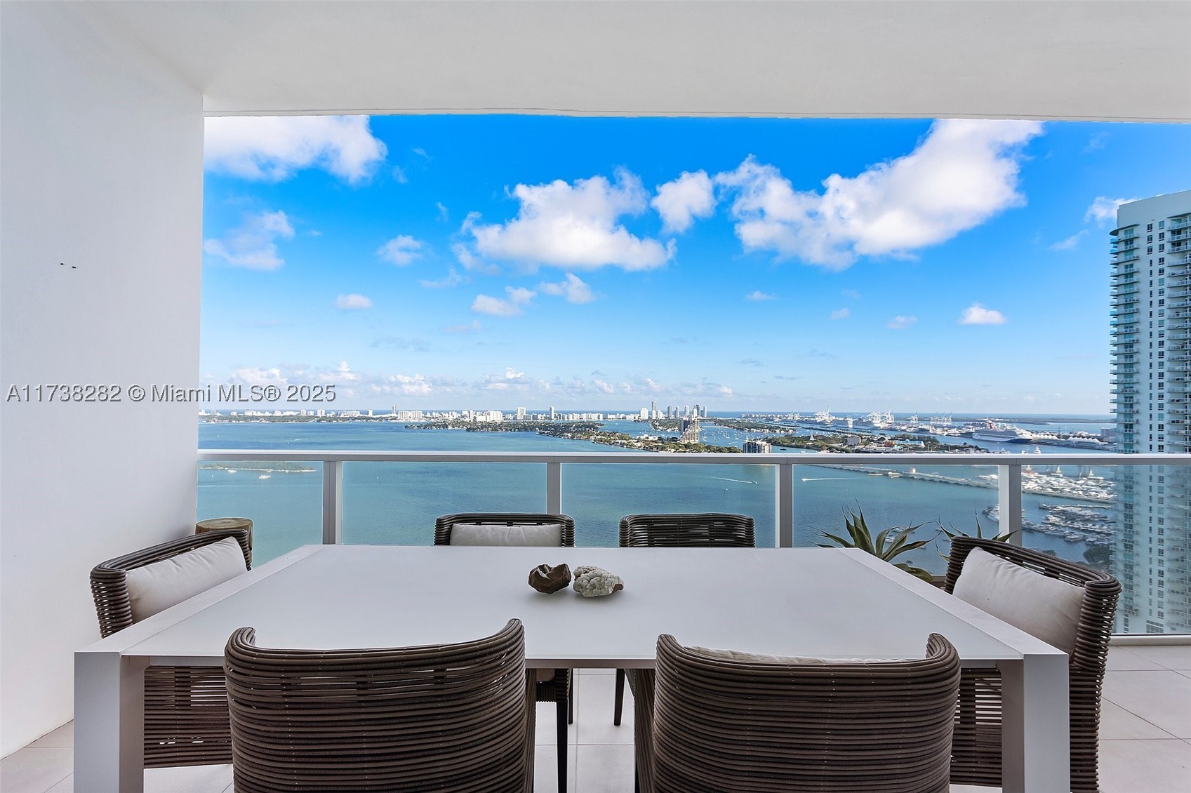 Forever unobstructed views of the bay and ocean. This is the only unit designed by the Lenny Kravitz design team which designed the common areas of Paramount Bay. Stunning Brazilian hardwood floors, custom light fixtures, electric blinds. Wolf and Sub-Zero, Bosch central A/C.  Private elevator, a flow though East to West floor plan that affords great privacy. Easily converted to a 3 bedroom for families. The building occupies nearly a full city block, affording a level of luxury amenities not found elsewhere. Multiple pools, Spa, gym, kids room, Pilates room etc.