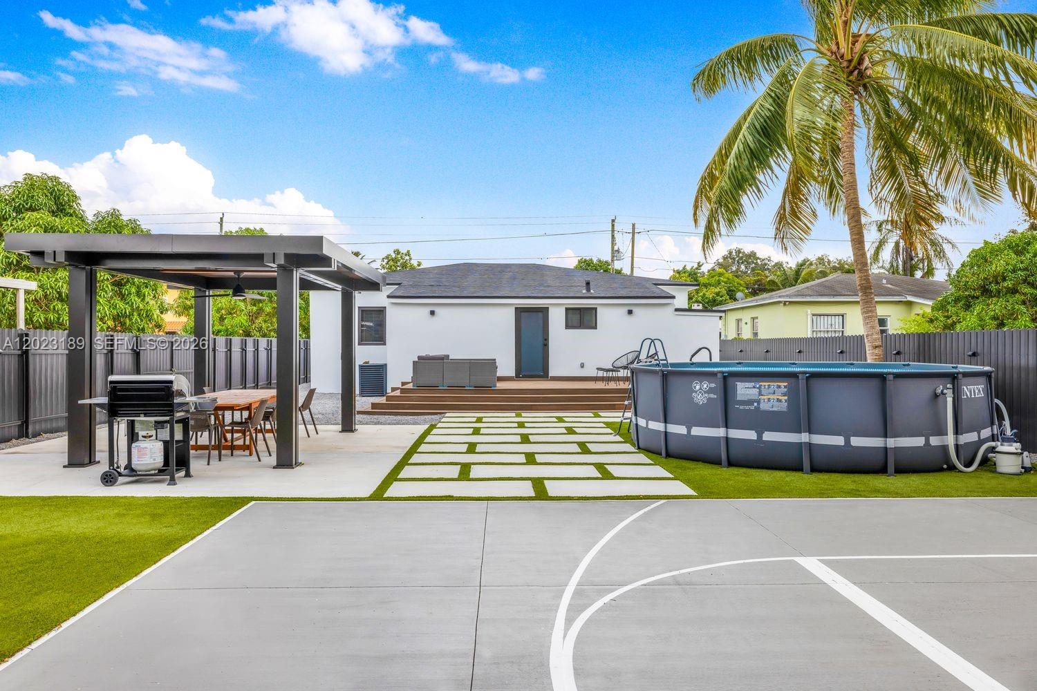 INCOME PRODUCING and fully renovated with permits, this 5-bedroom, 3-bath home is positioned for strong tenant demand, end-user appeal, or immediate investment potential. Just minutes from the Design District, the home offers a spacious, easy-flowing layout designed for everyday living and entertaining. The modern kitchen features black stainless steel appliances, sleek cabinetry, and generous space for gathering. Outdoors, the backyard is built to entertain with an above-ground pool, hot tub, basketball hoop, and covered dining area with room to grill. With strong monthly revenue and financials available upon request, this turnkey property offers flexibility, lifestyle, and income potential in one of Miami’s fastest-growing pockets.
