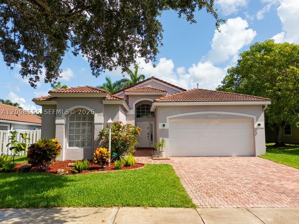13237 NW 15th Ct is the sought-after Teakwood model in Pembroke Falls, a beautifully maintained 3-bedroom, 2-bath single-family home with 2,438 square feet in the heart of Pembroke Pines, 33028. Step inside to a bright, open interior with soaring vaulted ceilings, ceramic tile flooring throughout the main living areas, and an abundance of natural light. The kitchen, finished with wood cabinetry and stainless steel appliances, opens to the living and dining spaces for easy everyday living and entertaining. The spacious primary suite is a true standout, with a walk-in closet and a renovated spa-style bath featuring a corner soaking tub and a separate glass-enclosed rain shower. Two additional bedrooms give you room for a home office or guests. Enjoy a durable barrel-tile roof, central cooling, a full 2-car garage, and a covered patio overlooking a fully fenced backyard framed by mature palms, with plenty of space to add a pool. As a resident of Pembroke Falls, you will have access to a guard-gated entrance, a clubhouse, community pool, and sports courts, plus a monthly association fee of $350. Set in an established Broward County community close to top-rated schools, shopping, dining, and major roadways, this home blends comfort, space, and a prime South Florida location. A wonderful opportunity to own in one of Pembroke Pines' most desirable neighborhoods. Bring your vision and make 33028 home.