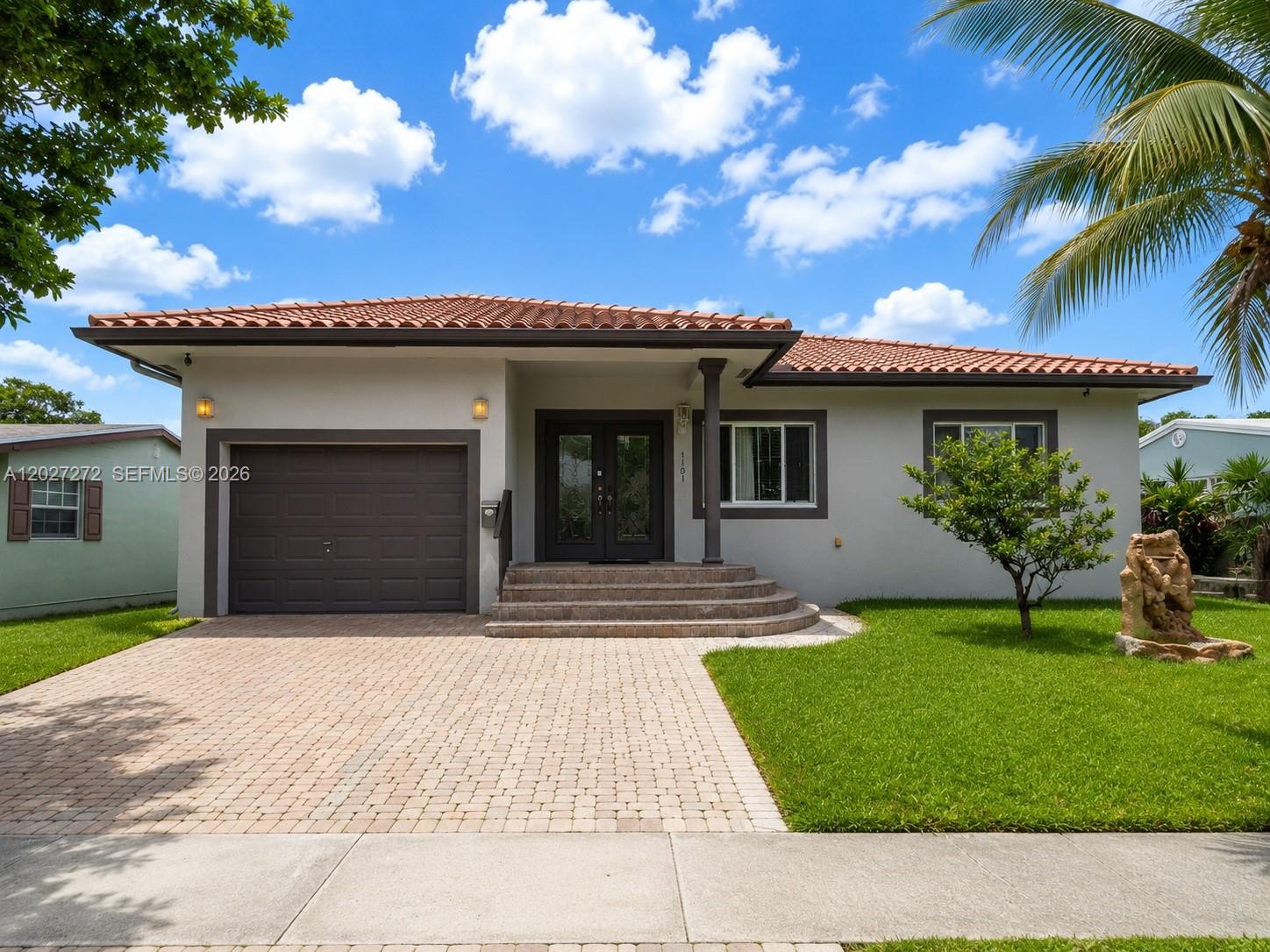 Beautifully maintained one-story residence in Hallandale Beach, ideally located east of US-1 and just minutes from the beach, Gulfstream Park, shopping, dining, houses of worship, hospitals, and major airports.  Built in 2008, this 4BR & 3 Bath home with garage offers a functional layout, quality construction, and excellent flexibility for a variety of living arrangements.
The interior features spacious living areas, a split floor plan, walk-in closets, laminate wood flooring, and impact windows and doors. A separate guest or in-law area with private entrance and second kitchen adds valuable versatility for extended family, guests, or multigenerational living. An open rear porch and fenced yard complete the outdoor space