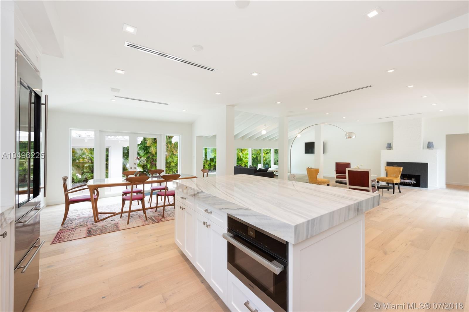 Enjoy the luxury of living on the gated & highly desirable Sunset Islands in this lush oasis. Full renovation completed in 2018, spectacular smart home situated on 13,800 sf lot features an open, airy floor plan, 3,282 adj sf, & bleached French Oak floors throughout. Gourmet kitchen features top of the line Wolf & Miele appliances, wine fridge & marble countertops. The open living/dining area perfect for entertaining offers abundant natural light. Unwind in the master suite with views of the sparkling pool, large walk-in closet & spa-like bathroom, his & hers vanities, separate shower & soaking tub. Entertain outdoors in your private backyard w/ heated saltwater pool & cabana area. Other features include hurricane impact glass windows and doors, Sonos sound system, NEST A/C & Ring doorbell