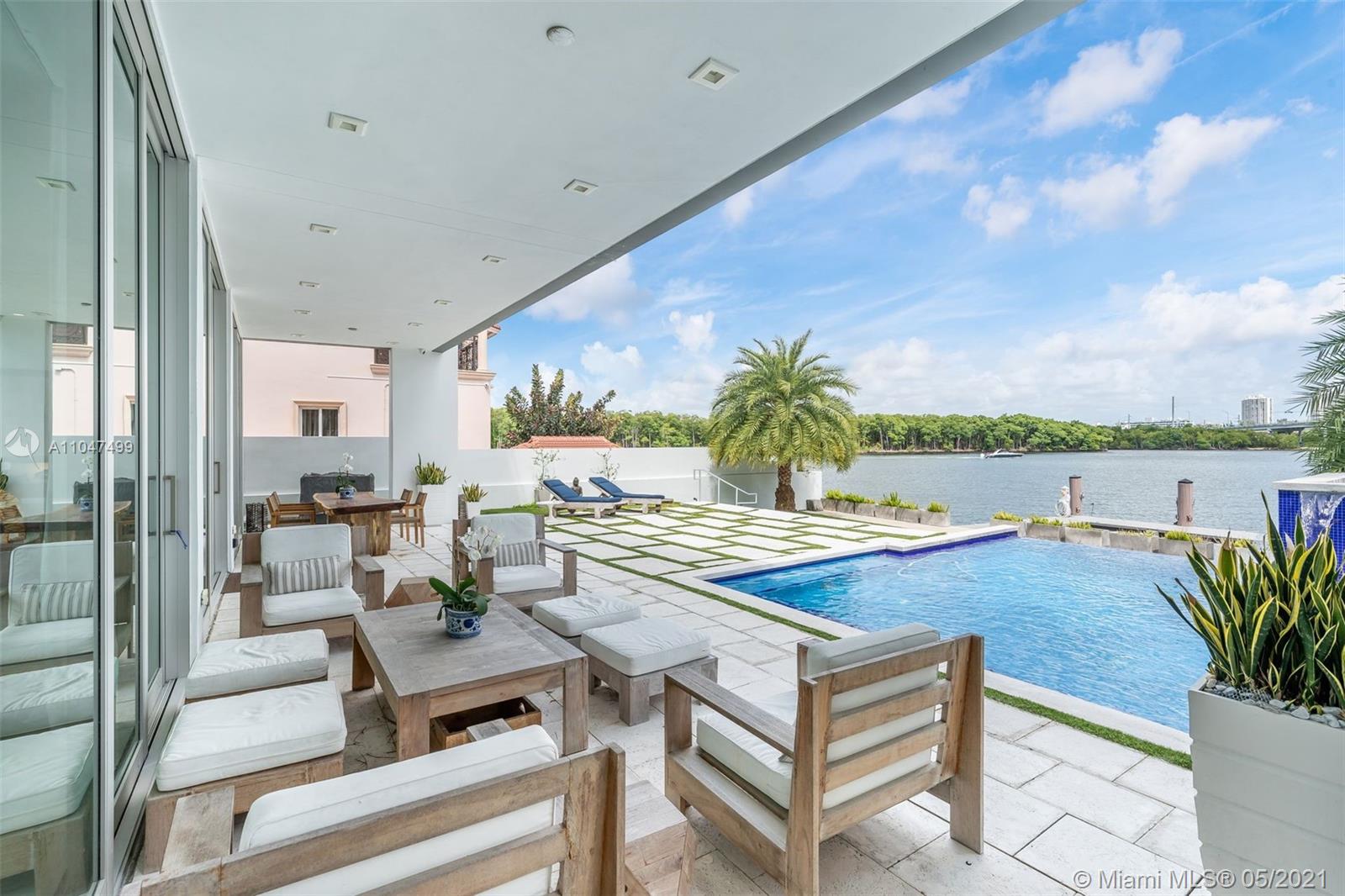 The architecture and execution of this contemporary waterfront masterpiece are truly unmatched. Located on secluded Atlantic Isle across from a deeded private beach lot, this modern custom-built residence boasts 10', 12' & 14' high ceilings and an abundance of windows offering natural light throughout. The currently features 4 bedrooms, large upstairs den, 5 1/2 baths, library den, a laundry room (can be second kitchen), and a garage with adjacent full bath currently used as a gym. Bold red exterior staircase leads to a rooftop terrace that could be build out as a 3rd level. Dock can accommodate 60' vessel, custom-designed infinity pool by VanKirk, surrounding home IP cameras, professional basketball hoop, custom-designed electric security gate, front area can accommodate up to 6 cars.