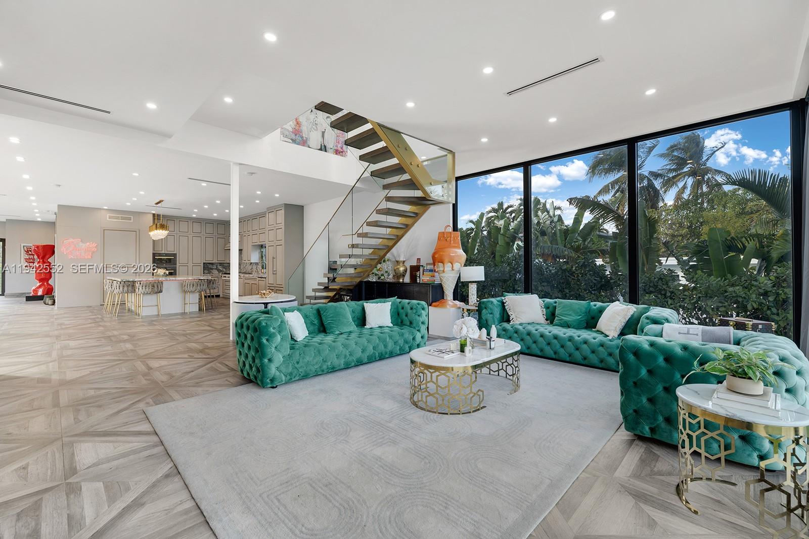 Step Inside With Me! This contemporary waterfront residence located on the gated island of Biscayne Point was reconstructed in 2022 by a meticulous owner. The home offers European touches throughout its bright interiors and impresses with its high ceilings, all while surrounded by walls of sliding glass. Designed for everyday use and entertaining, the professional-grade chef’s kitchen features Miele appliances, an oversized full slab island with a built in-dining table, contemporary cabinetry, and sleek flooring throughout the home. A floating staircase with glass panels leads to the second level, which is fully dedicated to the primary suite. The primary offers a spacious bath with modern finishes, a glamorous dressing room, and private terrace with water views. The outdoor area includes a waterfront backyard with generous green space, BBQ area, a lounge, and sizable dock for your boat. And, the infinity-edge pool is the central focal point of the home. A  garage, gated entry, automated AC controls, and appropriate guest bedrooms complete this offering. Biscayne Point is conveniently located minutes from Bal Harbour shopping and dining, the beach, and other Miami Beach cultural destinations.