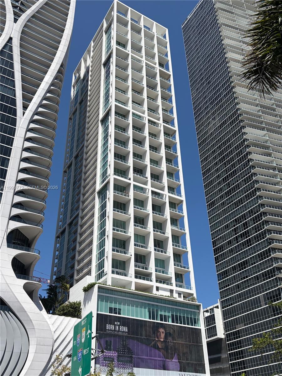 Rarely available corner residence at Ten Museum Park offering dramatic two-story loft living with soaring ceilings and walls of glass showcasing the breathtaking bay, ocean, park, Gov’t Cut and the Cruise ships, park, and skyline views. Abundant natural light, expansive living and dining areas, private balconies, and desirable split-bedroom floor plan. Enjoy luxury amenities, full-service living, and an unbeatable location just steps from museums, waterfront parks, dining, shopping, and Miami’s top entertainment destinations.
