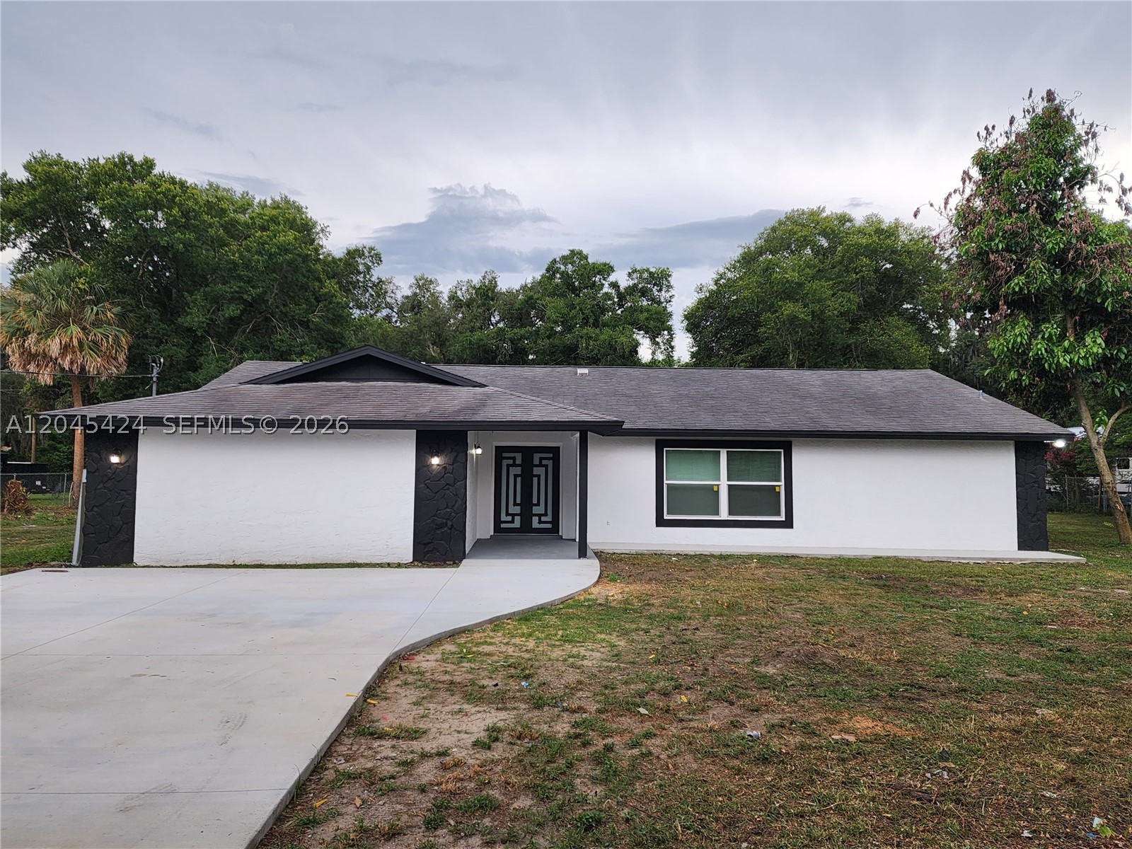 One of a kind, completely remodeled house, 4 bedrooms, 2 bathrooms, new kitchen with a beautiful island with sparkling white quartz countertop, new stainless steel appliances, new impact windows and doors, new porcelain floor, new bathrooms. Almost 1.5 Acres with plenty of room for all activities. A converted garage is now an oversized extra bedroom, It can be used for guests, or exercise room, workspace, as a playroom. Oversized laundry with new Washer & Dryer, new screen terrace and porcelain floor, new four car concrete driveway. Great location, close to restaurants and shops. This house is a dream come true. It's GOLD, It's not going to last!!!