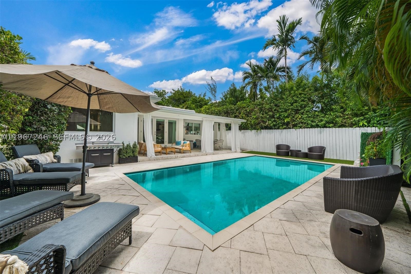 Ready to close on this deal? Discounted price !!Discover refined living in Miami Beach's best area.....This thoughtfully designed 3-bedroom home. The tastefully furnished interior includes a versatile laundry room that easily converts into a guest room with a convenient half bathroom. Cook and entertain in style with the well-appointed kitchen, complete with top-of-the-line appliances and a subtle wine cellar touch.Enjoy the open living and dining, along with a patio overseeing a heated pool and lush greenery, all guarded by a security system. Park up to 3 cars in the circular driveway.