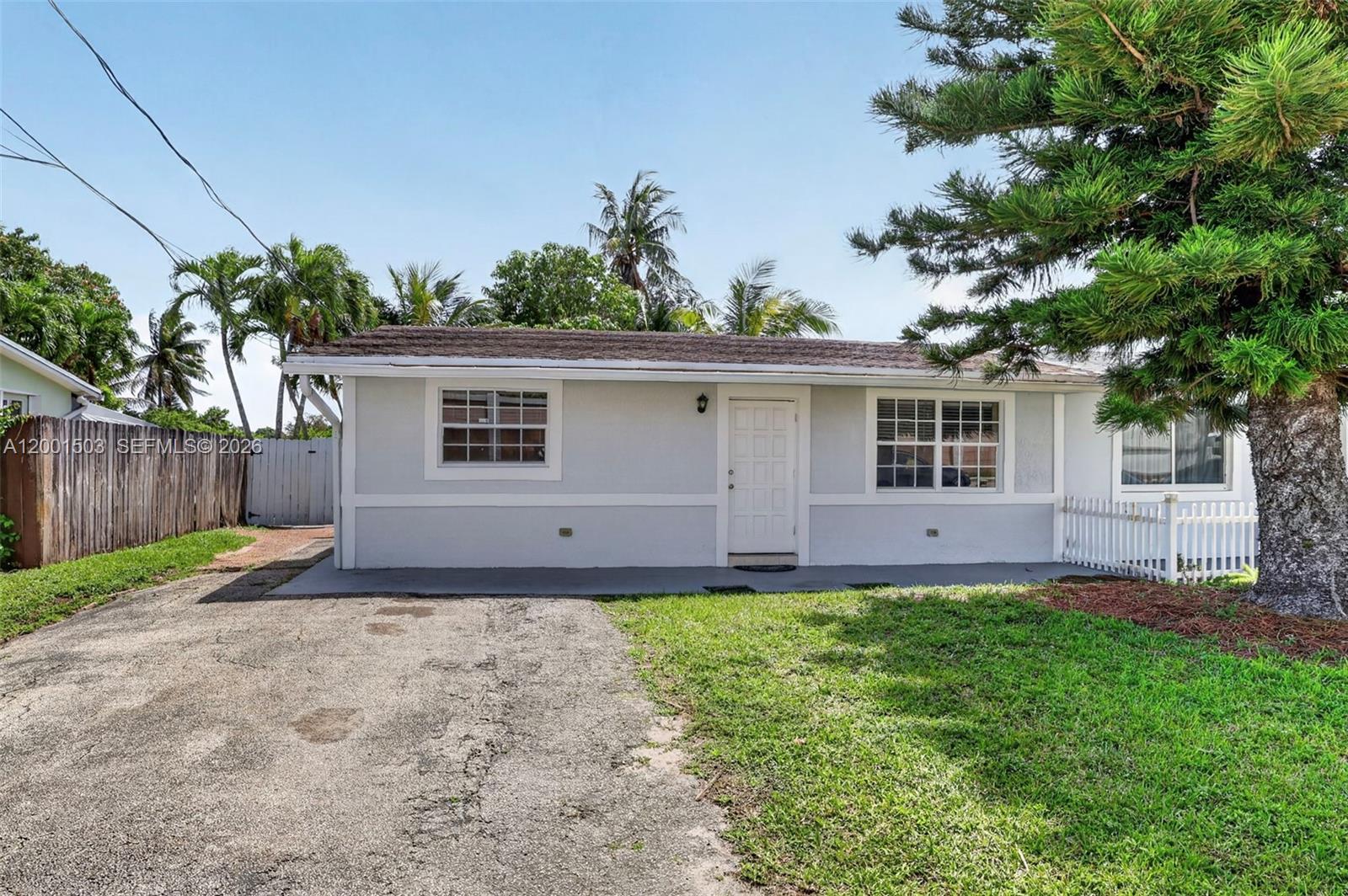 Beautifully renovated 2 Bedroom, 1 Bath home with stunning lake views and NO HOA! New Roof!!This move in ready property features a bright, beautifully renovated kitchen with soft close cabinets, stylish backsplash, and appliances are 3 years old or less. Matching nice window shades throughout the home add a clean ,bright and cohesive look. The remodeled bathroom features a tub/shower combination with updated finishes.  A separate washer/Dryer room adds convivence and extra storage space. Enjoy relaxing mornings on the front porch and peaceful evenings on the back porch in a BBQ dinner in your fenced in yard overlooking the water. The Tropical Landscaping is a true highlight, featuring Mango, Banana, Coconut. sugar cane and Palm Trees, all set against serene lake views! The fully fenced yard offers privacy and room for pets, gardening, or entertaining. NO HOA means more freedom and fewer restrictions. As on a Quiet Dead End street!  Room for you to put in a pool!!