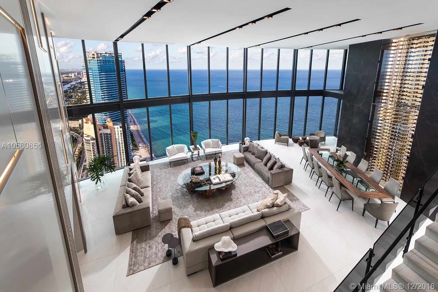 THE MOST SPECTACULAR TURN-KEY 2 STORY RESIDENCE IN THE PORSCHE DESIGN TOWER. IT IS FULLY FINISHED AND FURNISHED BY ARTEFACTO!! 21 ft CEILINGS . NEVER LIVED IN!!  6,684 sf plus an 1,128 sf 
4 CAR GARAGE  & UNOBSTRUCTED OCEAN AND INTRACOASTAL VIEWS AT THE SAME TIME. VIEWS ARE FOREVER! 4 BEDROOMS, 5.5 BATHROOMS, 4 CAR GARAGE, MOVIE ROOM, 2 LIVING ROOMS, OFFICE, ELEVATOR, POOL, 2 BALCONIES. HUGE MASTER BEDROOM. OCEANVIEW MULTIPLE BATHROOMS, COMPLETE AUDIO/VIDEO SYSTEM AND ELECTRIC SHADES. HUGE 21 ft GLASS WINE CELLAR. EXQUISITE DESIGN . NEW TO THE MARKET!! ENJOY THE EXCLUSIVE PORSCHE TOWER IN THE BEST RESIDENCE!