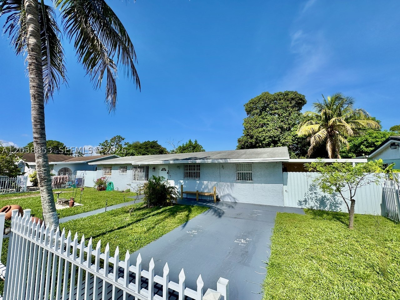 Excellent opportunity for both end-users & investors. Please note: the home next door is also available for sale (A12038844).
Located in a quiet, family-oriented neighborhood between St. Thomas University and Florida Memorial University, this versatile home offers flexible living options and strong potential. The home is currently configured with a private 1-BR/1-BA efficiency featuring a kitchenette, family room, and separate entry (was converted garage). This area can easily be converted back to the original layout. A 2024 mini-split AC unit services the efficiency area.
The main entry opens to a living/dining room, adjacent is the galley-style kitchen. 1-year-old 4-ton AC unit, and an approx. 8-year-old roof. Septic system was just cleaned and tested 6 months ago. Washer and dryer are on back patio.
Outside, the property brings a country feel to the city with lush vegetation, including banana, avocado and mango trees. Large storage shed w/electric. Fully fenced, including sliding front gates for secure parking.