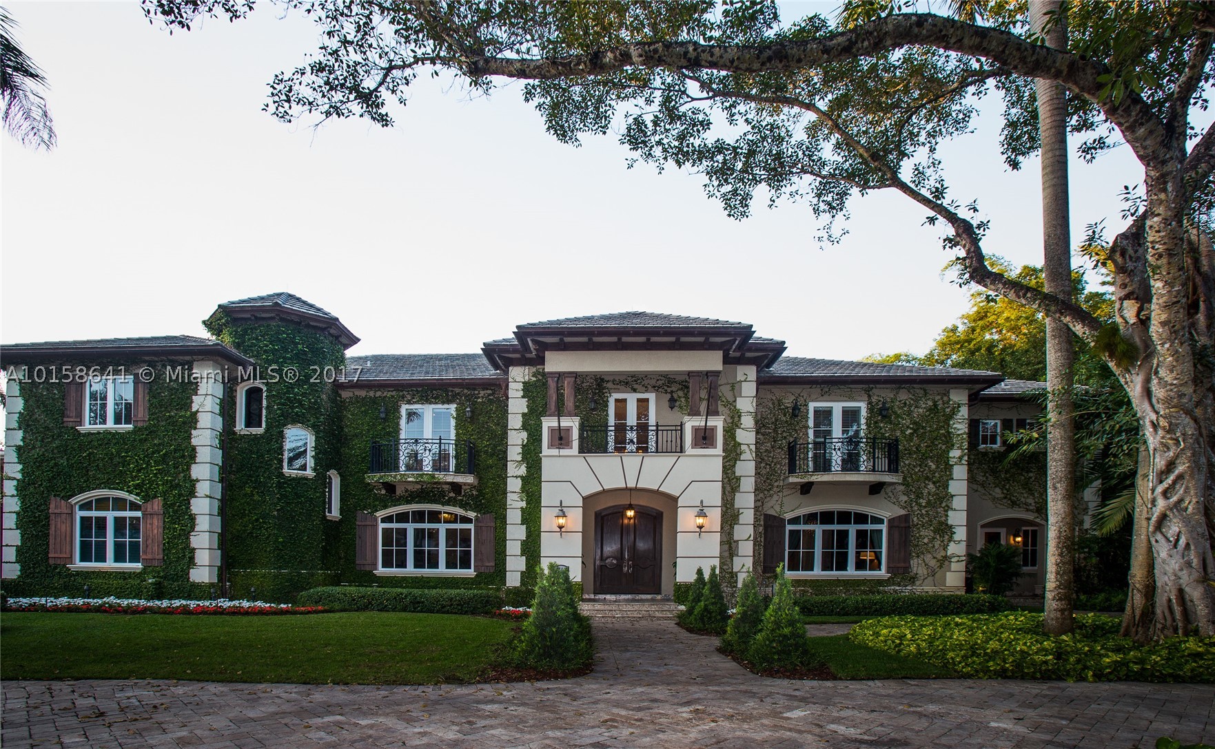 Re-Priced & Motivated:Miami Splendor:Private Estate enclave Ponce-Davis area;Contemporary Tudor Design integrating indoor elegance w/outdoor living. INSIDE: Features large rooms,volume ceilings, Lg.kitchen gas range,Office,wine room,billiard room, elevator, maid's room OUTSIDE:Impact Windows &Doors; covered poolside outdoor gathering area;outdoor kitchen with bar; pool with spa and walk-in beach platform  swim-up seating; putting green;Whole House Generator;Children Play ground; Mosquito Misting System;