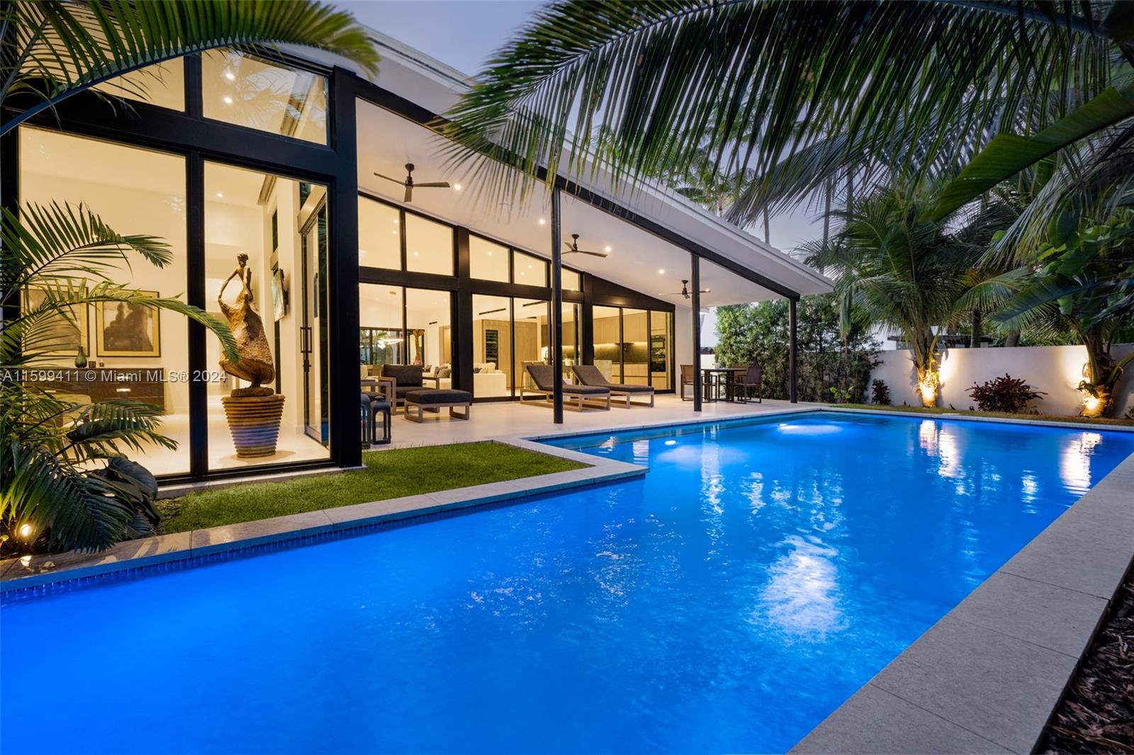 Welcome to your Mid-Century Modern masterpiece where timeless elegance meets contemporary luxury. Completed in 2022, this architectural beauty boasts features that redefine modern living. A seamless fusion of indoor-outdoor living, stunning floor-to-ceiling glass doors connect the interior to the patio & lush tropical retreat with a sparkling pool and a cascading waterfall.
This meticulously designed residence offers 4 bedrooms and 3 bathrooms, every detail has been carefully curated to reflect sophistication and style, from the Italian flooring to the leathered granite counters and terrazzo marble island.