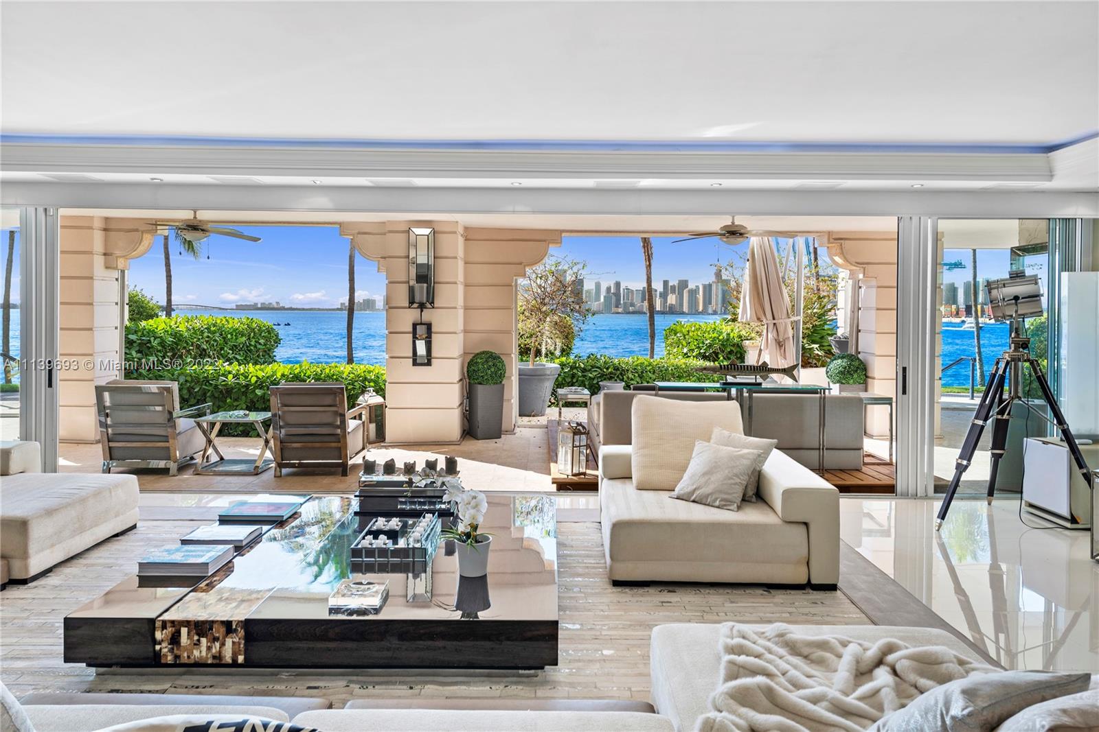Experience Fisher Island living at it's finest in this stunning renovated ground floor Bayview unit. This one of a kind masterpiece encompasses 6,209 sq ft interior and 2,516 sq ft of expansive terraces overlooking the Miami downtown skyline and Biscayne Bay with breathtaking sunset views! This 5 bedroom, 5 bath + 2 powder room residence has been professionally designed with FENDI wallpaper and door panels throughout. The unit showcases: spacious open living room with a bar and formal dining, exquisite white porcelain & oak floors, a Chef's kitchen with top of the line appliances, an eat-in center island, a built-in surround sound system and many more features. Visit this exceptional fully furnished unit! Easy to show!