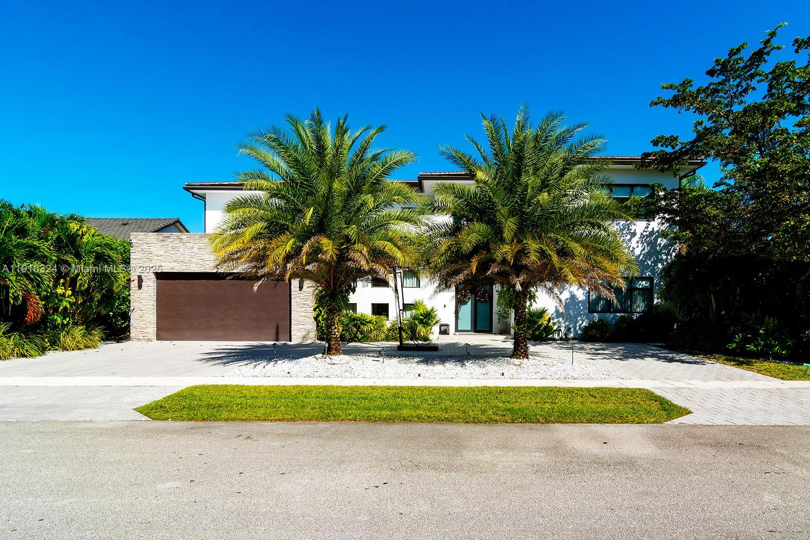 This 5BD/4.5BA ultramodern showpiece—featured on Netflix’s Designing Miami—delivers standout style and turnkey luxury. Completed in 2020, the home offers a theater room, double-sided wine cellar, 8' Italian doors, and custom finishes throughout. The European-inspired kitchen flows beautifully for entertaining, while Juliet balconies add architectural charm. Set on a premium waterfront lot with lush tropical landscaping and a private putting green, this property blends design, lifestyle, and value in one unforgettable offering.
