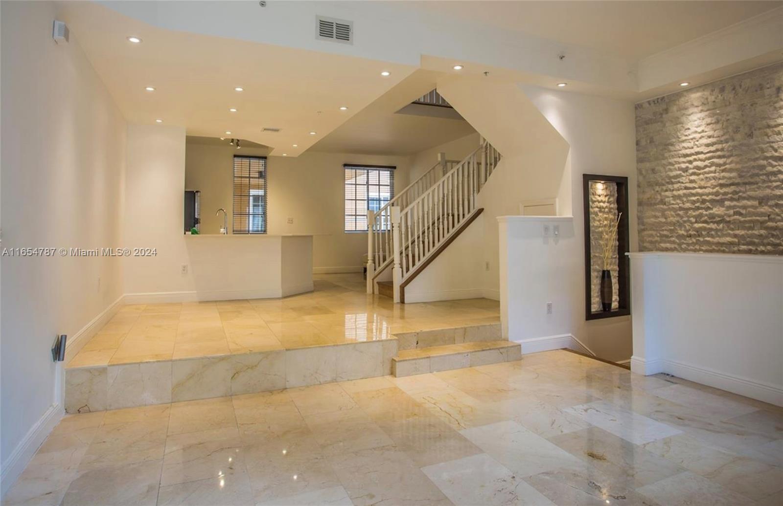 Exquisite Fully Renovated Tri-Level Townhome in Aventura. Beautifully renovated townhome in the exclusive gated community of Aventi. This luxurious 3-bedroom home features modern bathrooms with the finest high-end materials and sleek finishes. The main level includes a stunningly upgraded kitchen equipped with cutting-edge appliances, elegant marble flooring and custom closets by The Container Store. The third level showcases premium bamboo floors, adding warmth and style. The home includes a spacious 2 car garage with additional parking for a third vehicle outside. Residents enjoy community amenities such as a  pool, gym and clubhouse with easy access to the canal. Conveniently located within walking distance of Aventura Mall, premier dining options and some of the top-rated schools.