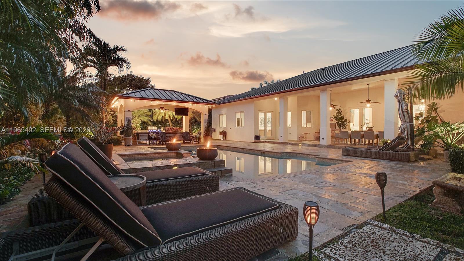 Repositioned at $2,599,000. Best Value Opportunity in Palmetto Bay. Owner-built and thoughtfully upgraded, this expansive 6-bedroom, 5-bath residence offers soaring 14 to 16 ft ceilings and over 5,300 SF of living space designed for comfort and entertaining. Major capital improvements provide long-term peace of mind: 2020 double-insulated dark bronze metal roof, impact windows throughout, matching bronze gutters, two new A/C systems (2021), new pool pump (2024), and new sprinkler pump (2026). The outdoor setting is a true highlight with a gorgeous pool area surrounded by mature trees, coral rock fire pit, and a Paradise Grill outdoor kitchen with built-in refrigerator, ideal for gatherings year-round. Located on a quiet, secluded street with a two-car garage plus additional front carport, this home offers privacy while remaining close to premier schools including Palmer Trinity and Westminster Christian. Now strategically priced to reflect todays market, this property presents a rare opportunity to secure space, quality construction, and lifestyle in one of Palmetto Bays most desirable locations. This is not a house that needs a renovation project. It is a complete, move-in-ready estate for the buyer who refuses to compromise on space, privacy, or lifestyle at a value that Coral Gables and Pinecrest simply cannot match. Schedule your private tour today.