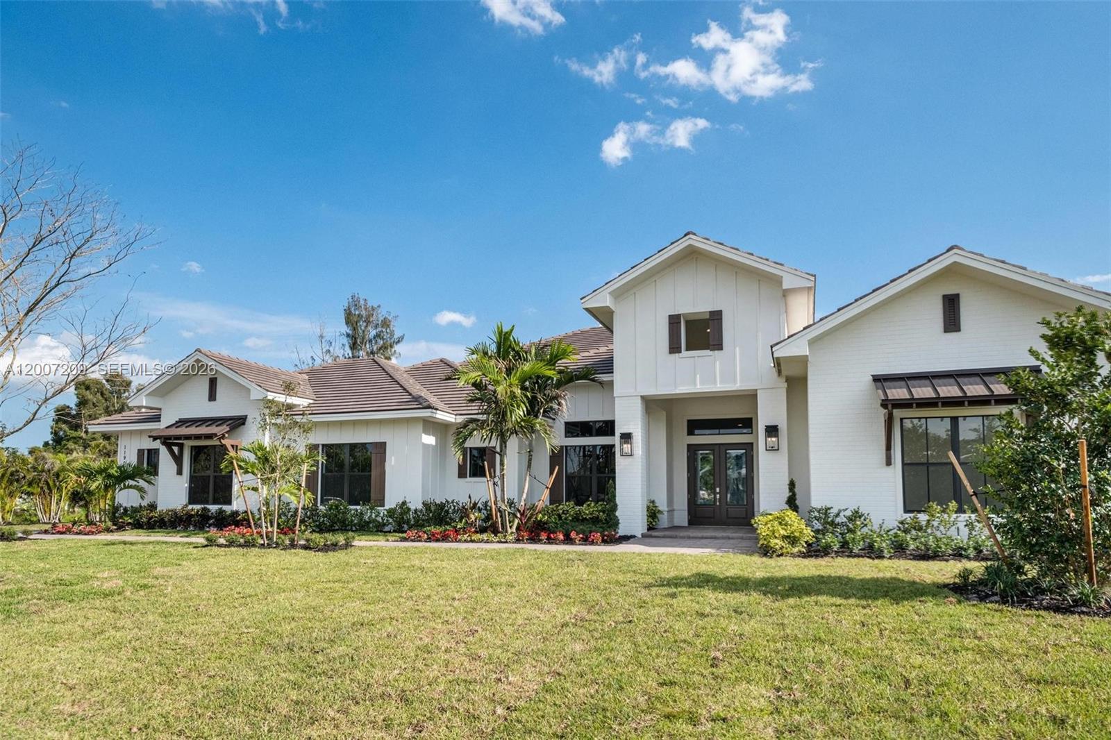 Introducing the LAUREL HOME — an extraordinary new luxury residence by renowned custom builder Lowell Homes, is located in the highly sought-after Flamingo Ranch Estates enclave of Davie. Perfectly positioned at the end of a quiet private cul-de-sac on prestigious Peaceful Ridge Trail, this exceptional one-story architectural masterpiece is surrounded by a collection of newly constructed luxury estates, all crafted with the signature quality and elegance Lowell Homes is known for. Set on an expansive 37,356 SF homesite with no HOA, this residence offers the ultimate blend of sophistication, privacy, and modern family living. The beautifully designed floor plan is thoughtfully curated for both everyday comfort and entertainment. The expansive living spaces flow seamlessly into the grand chef’s kitchen, formal dining room, family room and inviting breakfast nook. Designed to impress, the kitchen showcases top-tier JennAir appliances, premium quartz countertops & custom cabinetry. The private backyard retreat offers the ideal South Florida lifestyle with a luxurious pool, expansive covered entertaining areas, and lush surroundings that provide exceptional privacy rarely found in new construction. Located in the heart of Davie — one of South Florida’s most desirable equestrian communities — residents enjoy a unique blend of luxury estate living and country charm, with nearby equestrian trails & parks, fine dining and shopping. Exceptional private & public schools nearby.