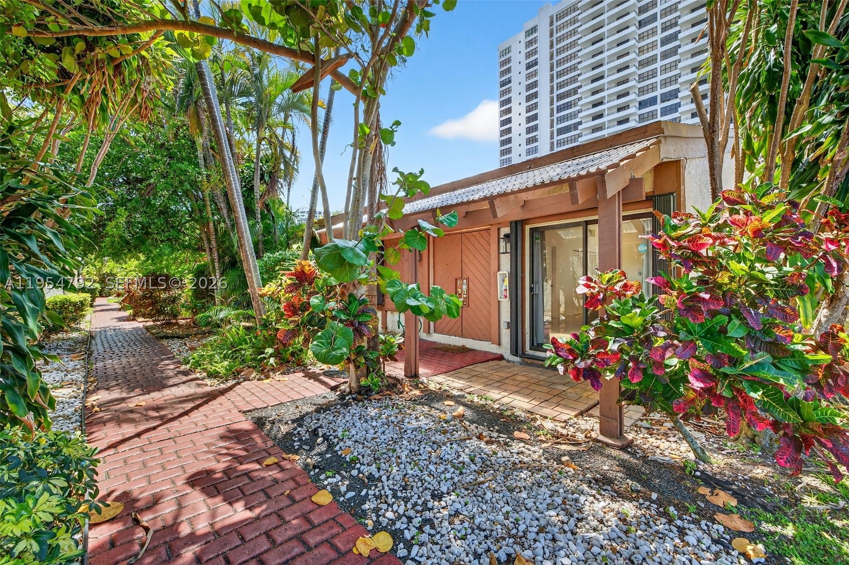 Truly one-of-a-kind and rarely available, this remodeled 3-bedroom waterfront corner home in the coveted Harbourwood enclave of Three Islands offers a unique coastal lifestyle with 33 feet of deeded dock directly in your backyard. Ideally positioned on Parkview Drive with easy access to Three Islands Blvd. Boating enthusiasts: step from your living room straight to the boat and cruise toward open water whenever the mood strikes! This seldom-available floor plan is highlighted by a rare in-house lanai—an exceptional architectural feature that floods the interior with natural light while creating a seamless indoor-outdoor flow. Soaring vaulted ceilings and expansive windows enhance the bright, airy ambiance, complementing the open-concept layout. The beautifully renovated kitchen anchors the main living area with sleek custom cabinetry, premium countertops, and a clean, contemporary design that blends sophistication with everyday comfort. Updated modern bathrooms and cohesive finishes complete the polished interior. An expansive waterfront deck extends the living space outdoors, perfect for alfresco dining and entertaining with tranquil water views. As a prime corner home, it enjoys added privacy, extra green space, and a more open feel within the community. Located just minutes from beaches, fine dining, shopping, and Gulfstream Park, this residence offers the rare opportunity to enjoy private waterfront living in one of Hallandale Beach’s most desirable neighborhoods.