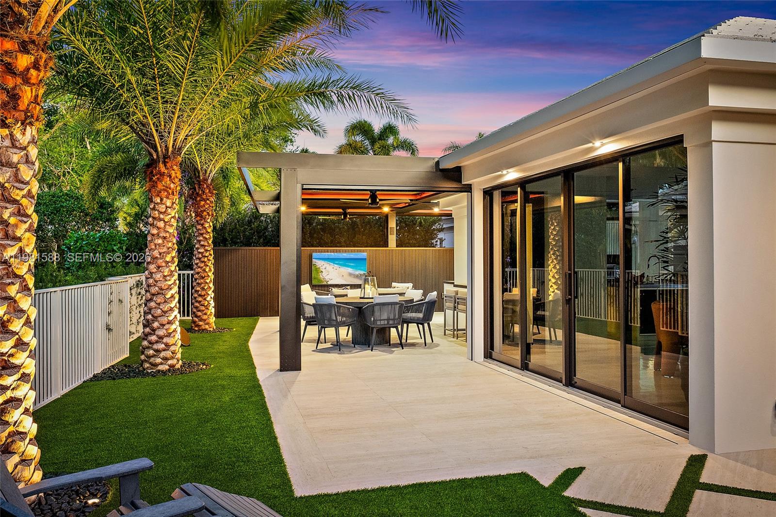 Fully renovated and thoughtfully re-designed, this exceptional cottage offers a rare blend of sophisticated design and effortless indoor-outdoor living. High-end finishes, sleek clean lines, and a bright open floor plan create a modern yet inviting atmosphere throughout the home. Expansive impact glass windows and doors fill the interiors with natural light while seamlessly connecting the living spaces to the outdoors. The redesigned layout maximizes flow and functionality—creating a one-of-a-kind cottage floor plan unlike any other in the community. Step outside to a backyard that rivals homes twice its size. Designed for both relaxation and entertaining, the outdoor space features multiple lounge areas, an impressive summer kitchen, and thoughtfully designed entertainment spaces.

A striking louvered aluminum pergola provides adjustable shade and architectural style, creating the perfect setting for gatherings day or night. Ideally located just moments from the Club, Tennis, Spa, and Marina, this truly special residence offers the perfect combination of luxury, comfort, and convenience in a beautifully reimagined cottage setting.
