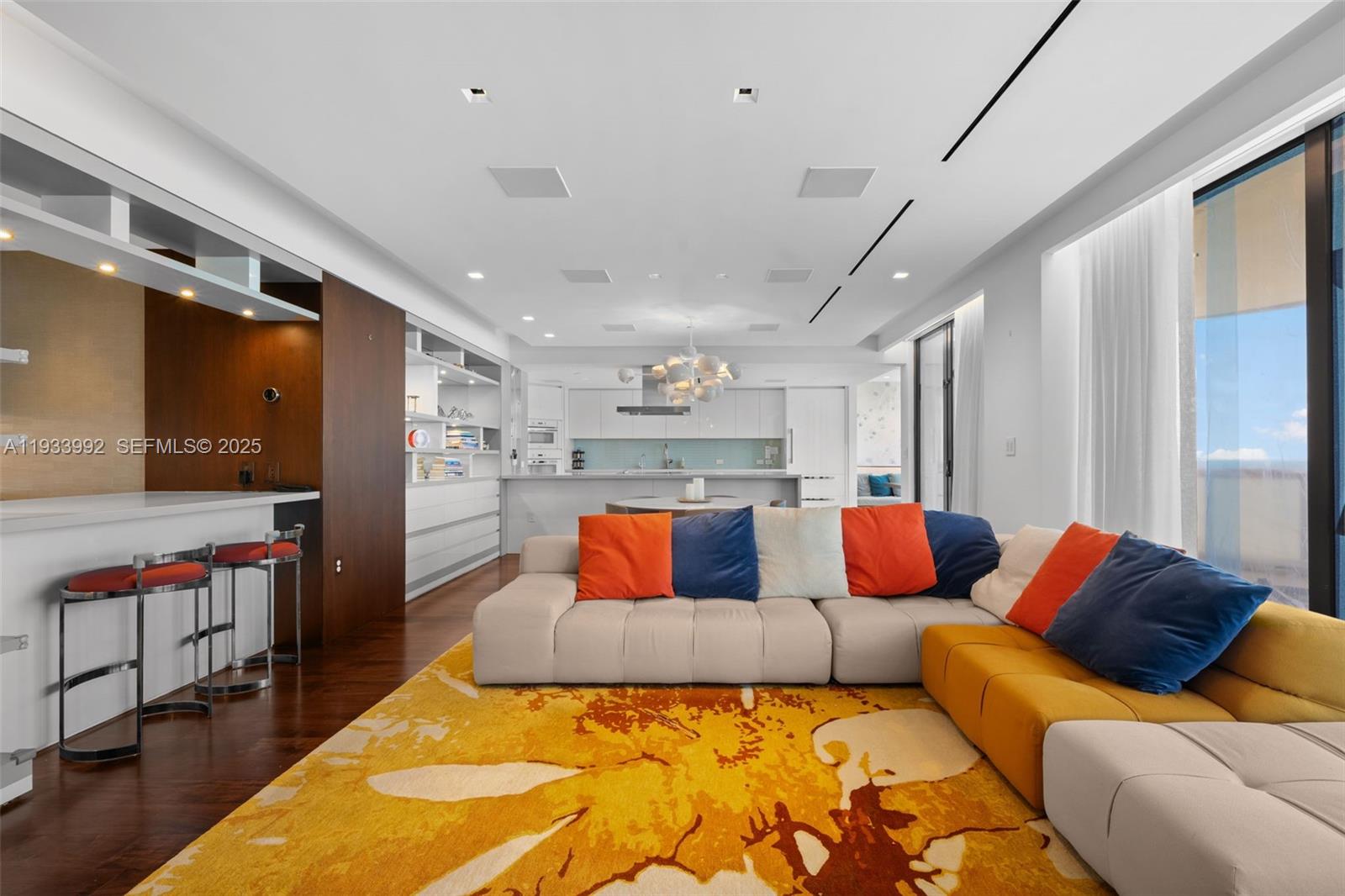 Experience refined luxury in this updated 3,230 sq ft flow-through 3-bedroom, 3.5-bath residence offering the best of both worlds—unobstructed direct ocean views and sweeping Intracoastal/city vistas. Accessed via private elevator, this rare floor plan features three ensuite bedrooms and an open-concept kitchen, dining alcove, living area with bar facing the ocean. Designed by STA Architectural Group, the residence showcases custom modern built-ins, high-end porcelain & engineered wood floors, and elegant marble finishes. Smart-home technology by Crestron, with Miele and Sub-Zero appliances, completes the home. The grand primary suite features a spa-like bath with double shower, steam, and a walk-in closet. Additional highlights of the unit include a utility room and extra storage room. Unit is offered furnished, AS -IS. Beachfront building is located steps from the world-renowned Bal Harbour Shops and Harding District, and within walking distance to houses of worship. Enjoy the amenities including spa services, private restaurant, valet, 24-hour security, pool and beach service, tennis courts, and more. Building exterior is under renovations. Balconies for this unit are expected to be re-open in April 2026.