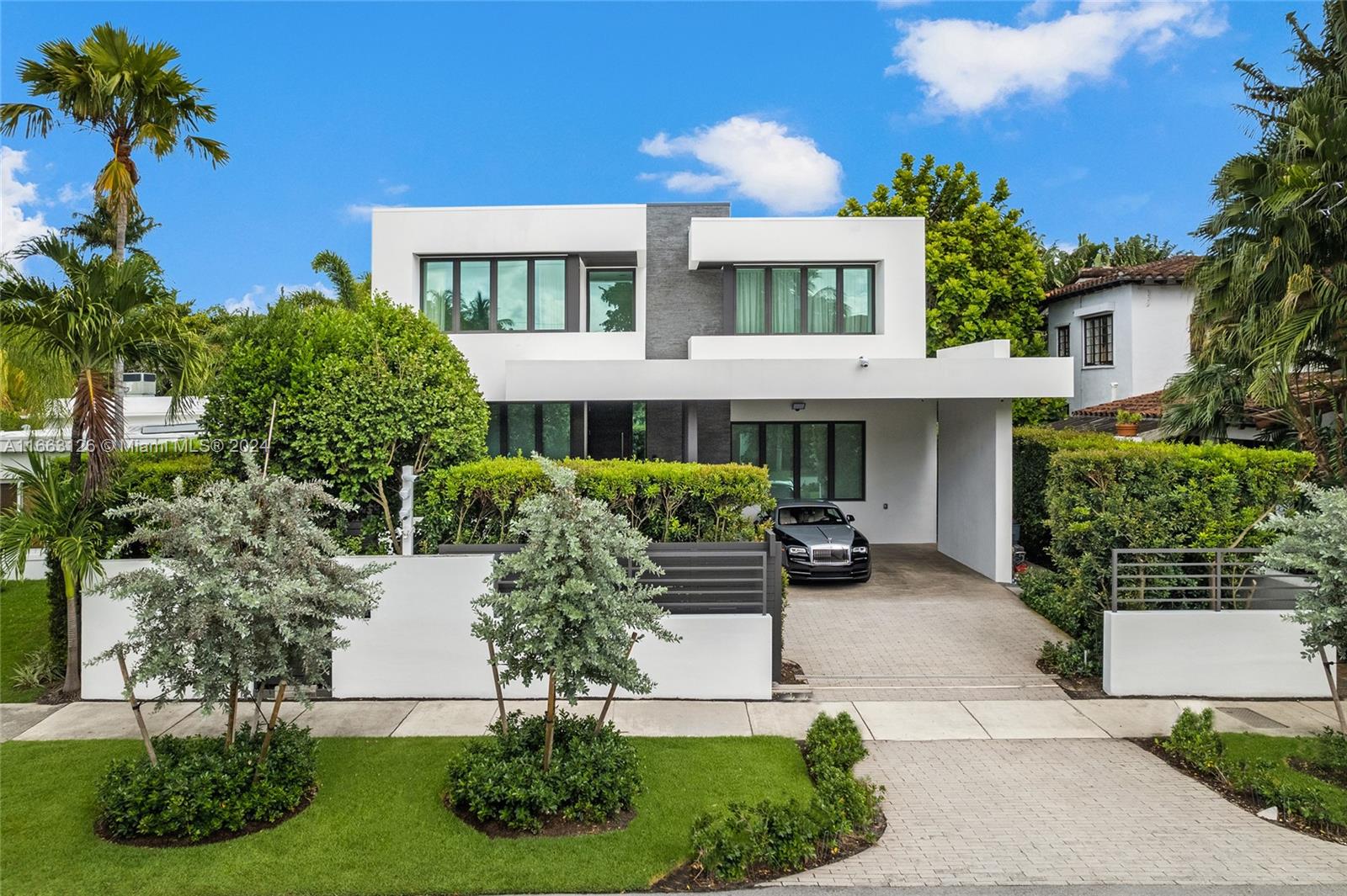 Immerse yourself in modern luxury on North Bay Rd with this stunning architectural masterpiece. Spanning 4,524 SF, this home features meticulously designed interiors, upscale finishes, and soaring 10-foot ceilings, offering an ideal setting for both refined living and entertaining. The seamless indoor-outdoor layout includes a spacious outdoor oasis with a covered dining area, lounge, summer kitchen, heated saltwater pool and an artificial turf yard. State-of-the-art amenities include a Control4 system with cameras, Sonos, a full-house generator, upstairs laundry, gym, office, and gated entrance with covered parking. Nestled in the exclusive Upper North Bay, enjoy ultimate privacy while being just minutes from world-class beaches, shopping, dining, and the vibrant lifestyle of Miami Beach.